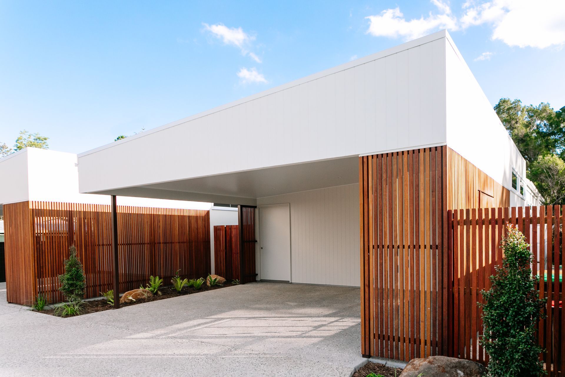 A white house with a wooden fence around it