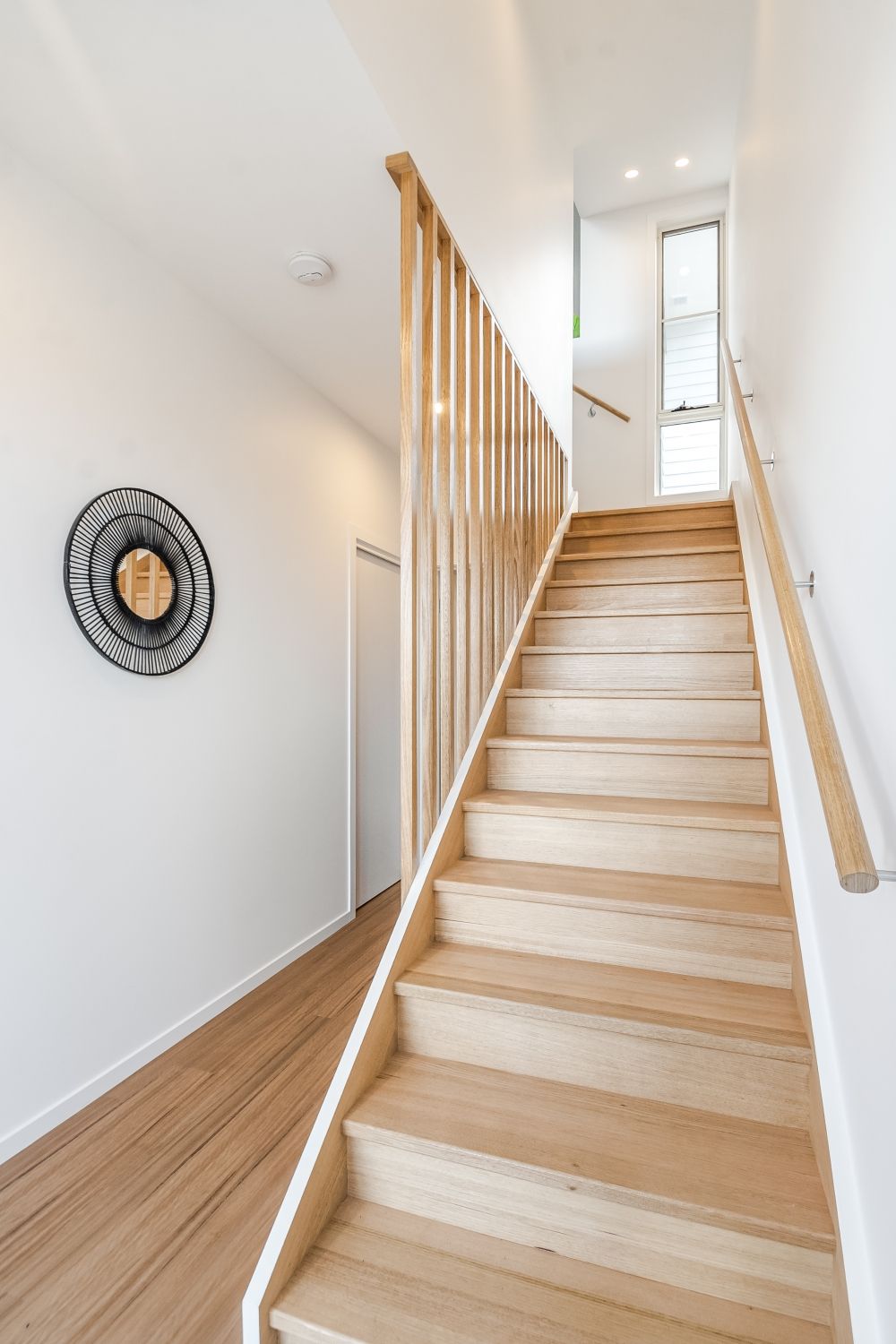 A wooden staircase leading up to the second floor of a house.