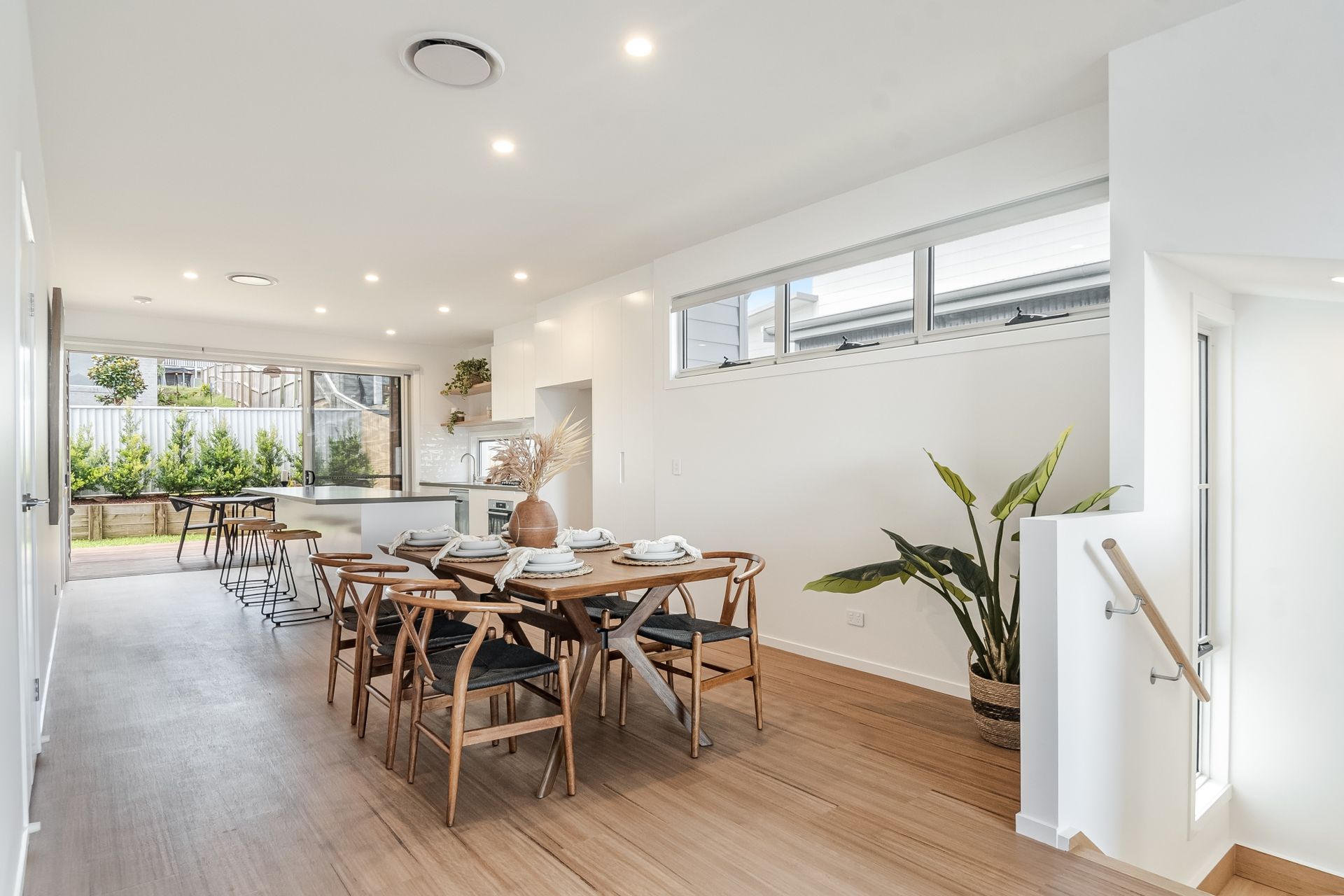 A dining room with a wooden table and chairs in a house.