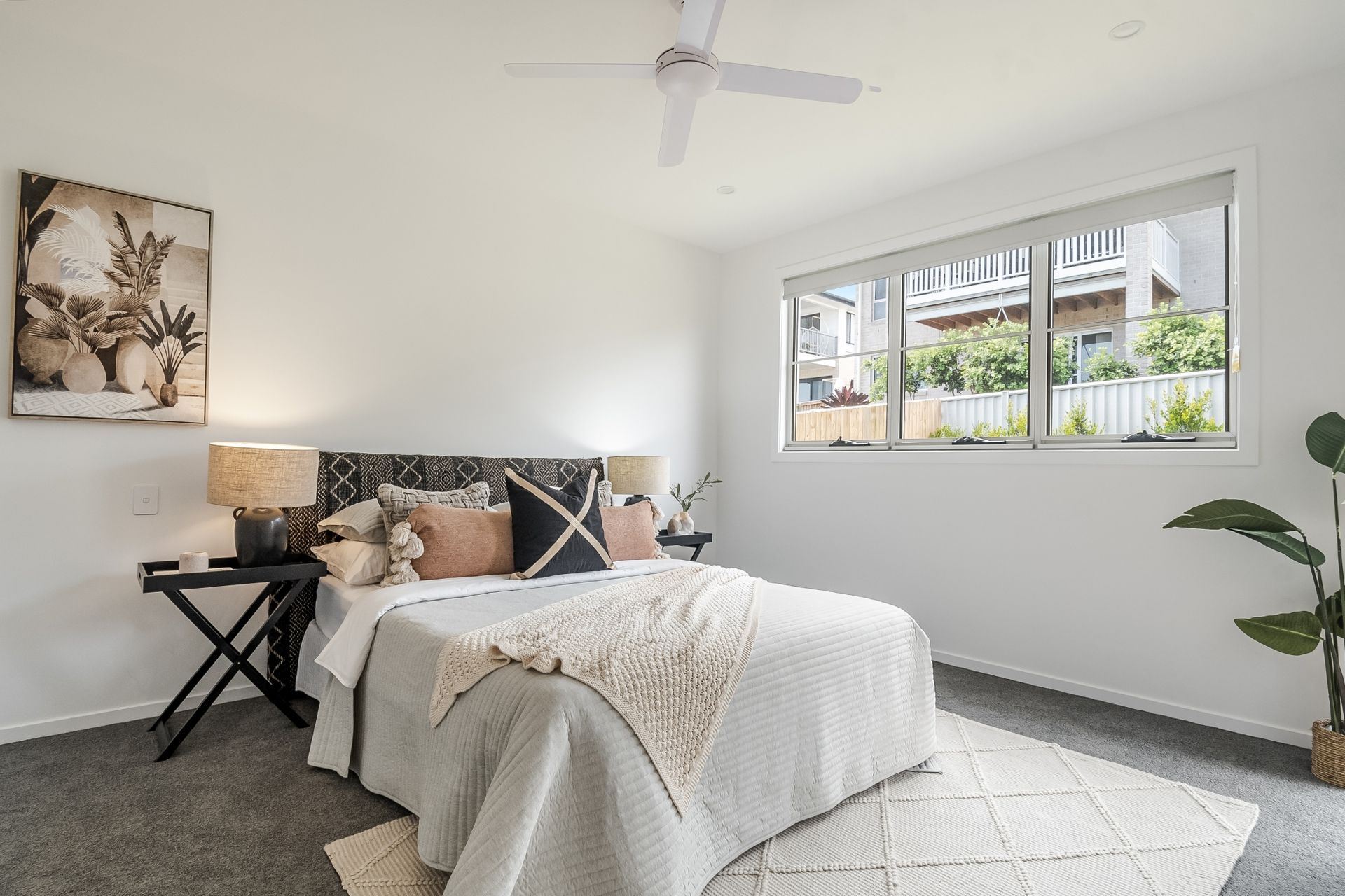 a bedroom with a bed and a ceiling fan .