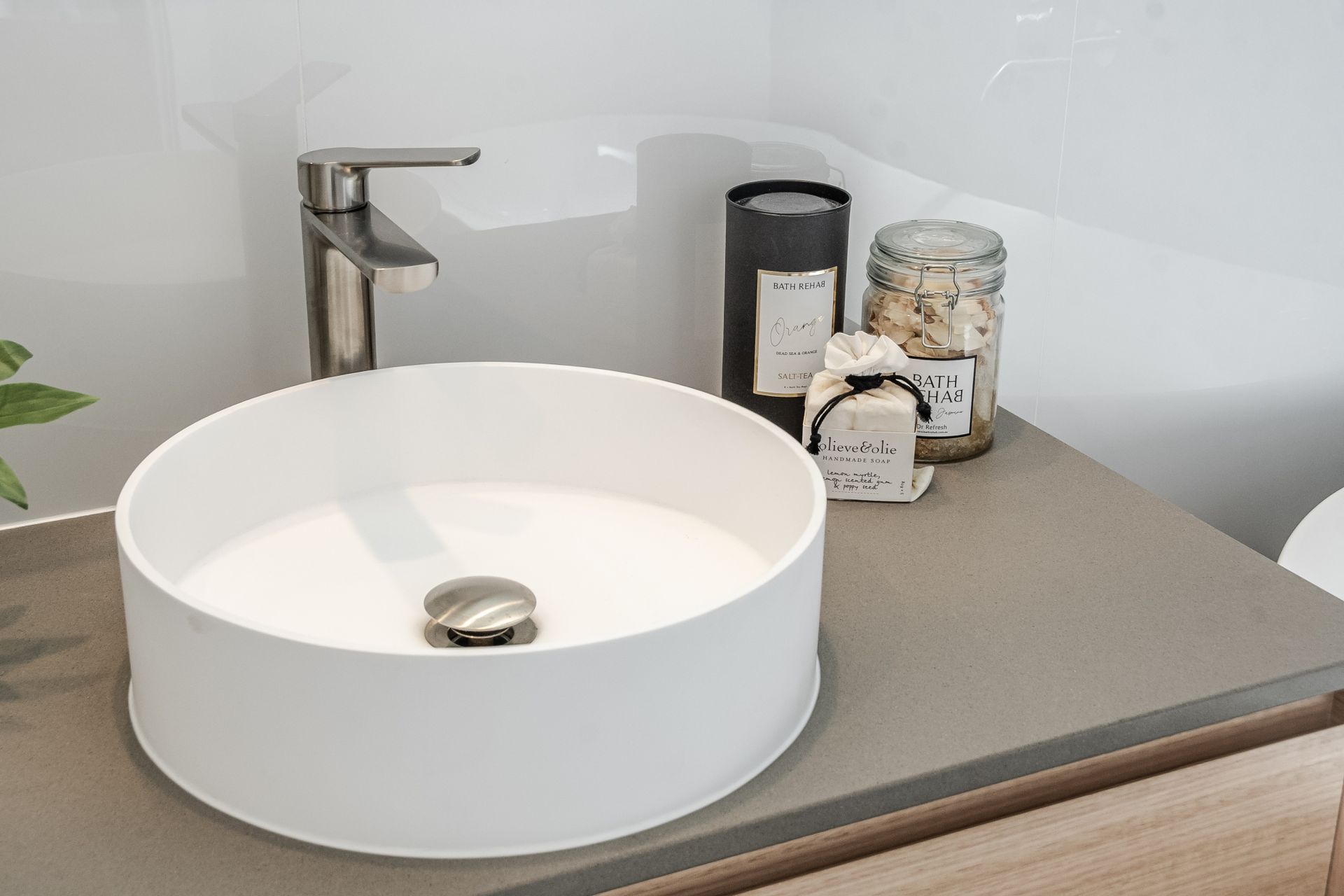 A bathroom sink with a faucet and candles on the counter.