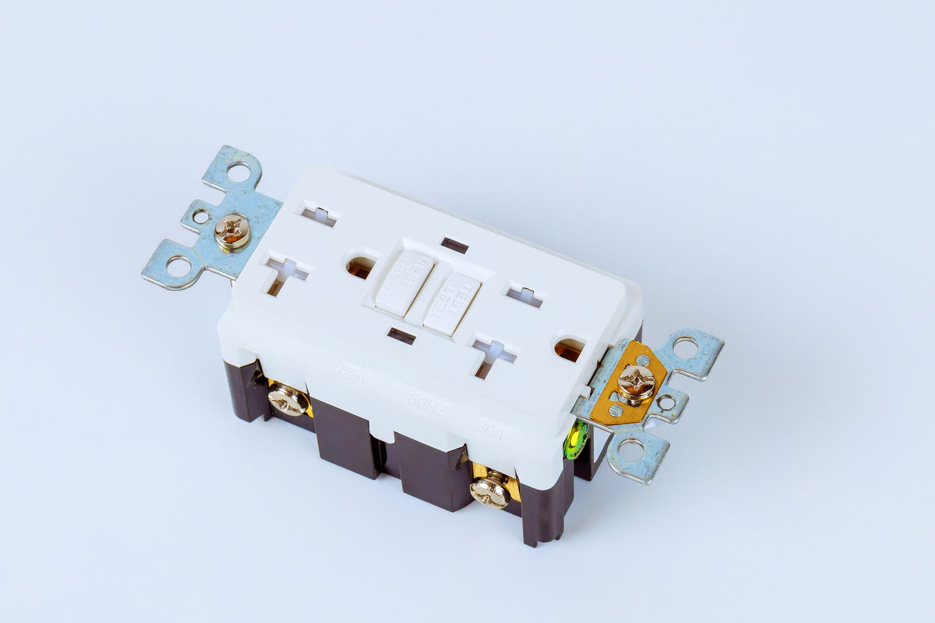 White electrical switch with exposed metal terminals and blue mounting tabs on a light background