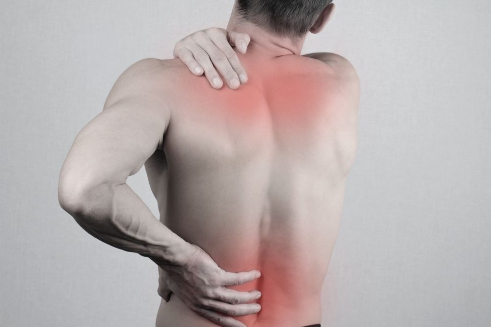Man with Back Pain, Hand on Shoulder, Red Highlight Indicating Pain — My Chiropractor Mackay City in Marian, QLD