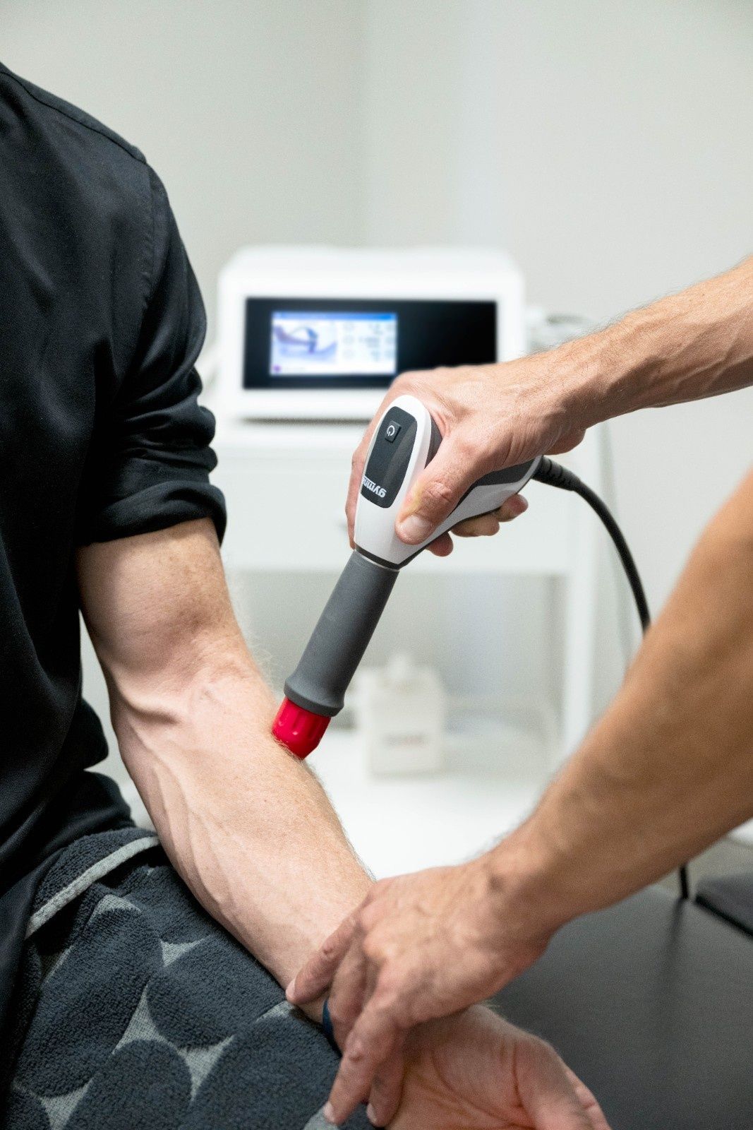 Chiropractor using an adjusting tool on a patient's back — My Chiropractor Mackay City in Mackay, QLD
