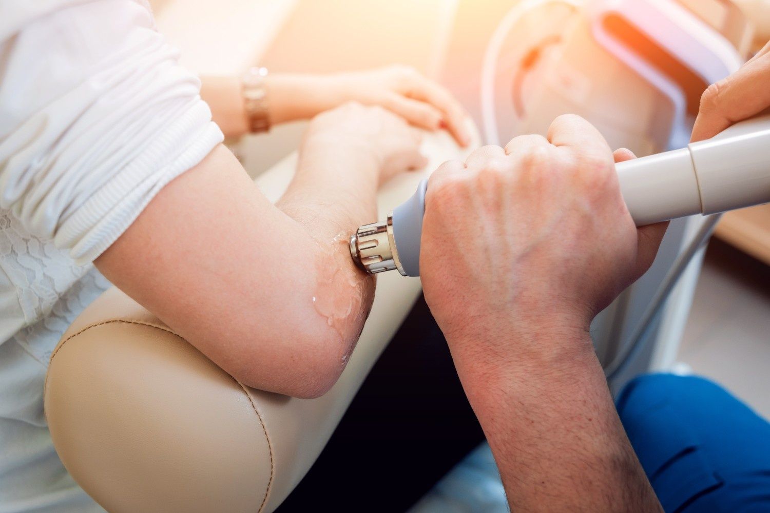 Person Receiving a Medical Procedure on Their Elbow with A Device — My Chiropractor Mackay City in Moranbah, QLD