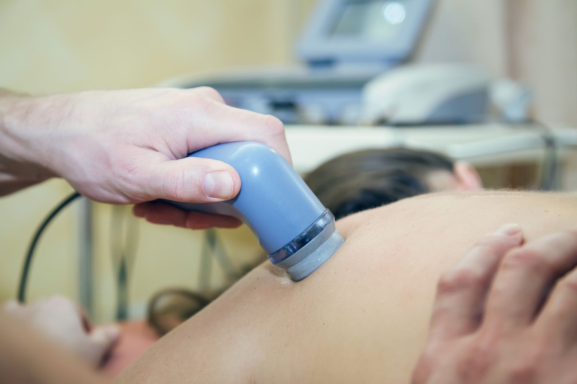 Therapist Using Ultrasound Device on A Patient's Shoulder — My Chiropractor Mackay City in Airlie Beach, QLD