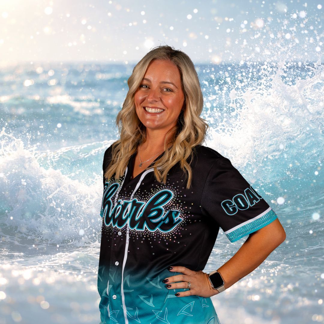 Woman smiling, wearing a Sharks jersey, set against a background of ocean waves.
