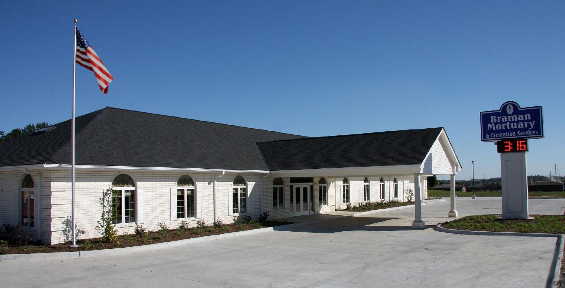 White building with an American flag; the sign reads 