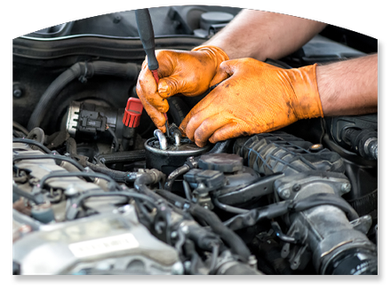 Claudino’s Auto Repair logo in blue and white on a dark car engine background