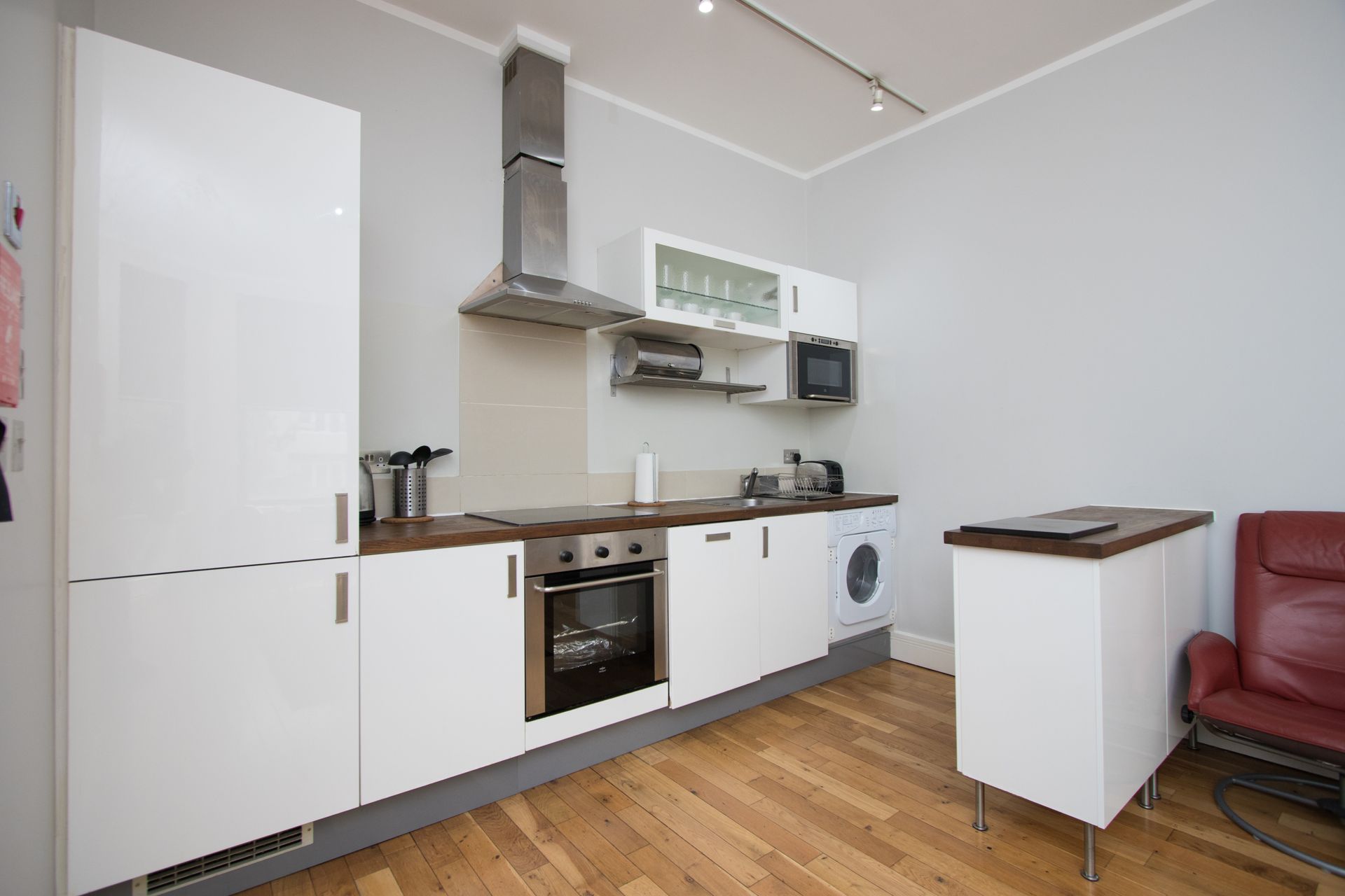 A kitchen with white cabinets and stainless steel appliances
