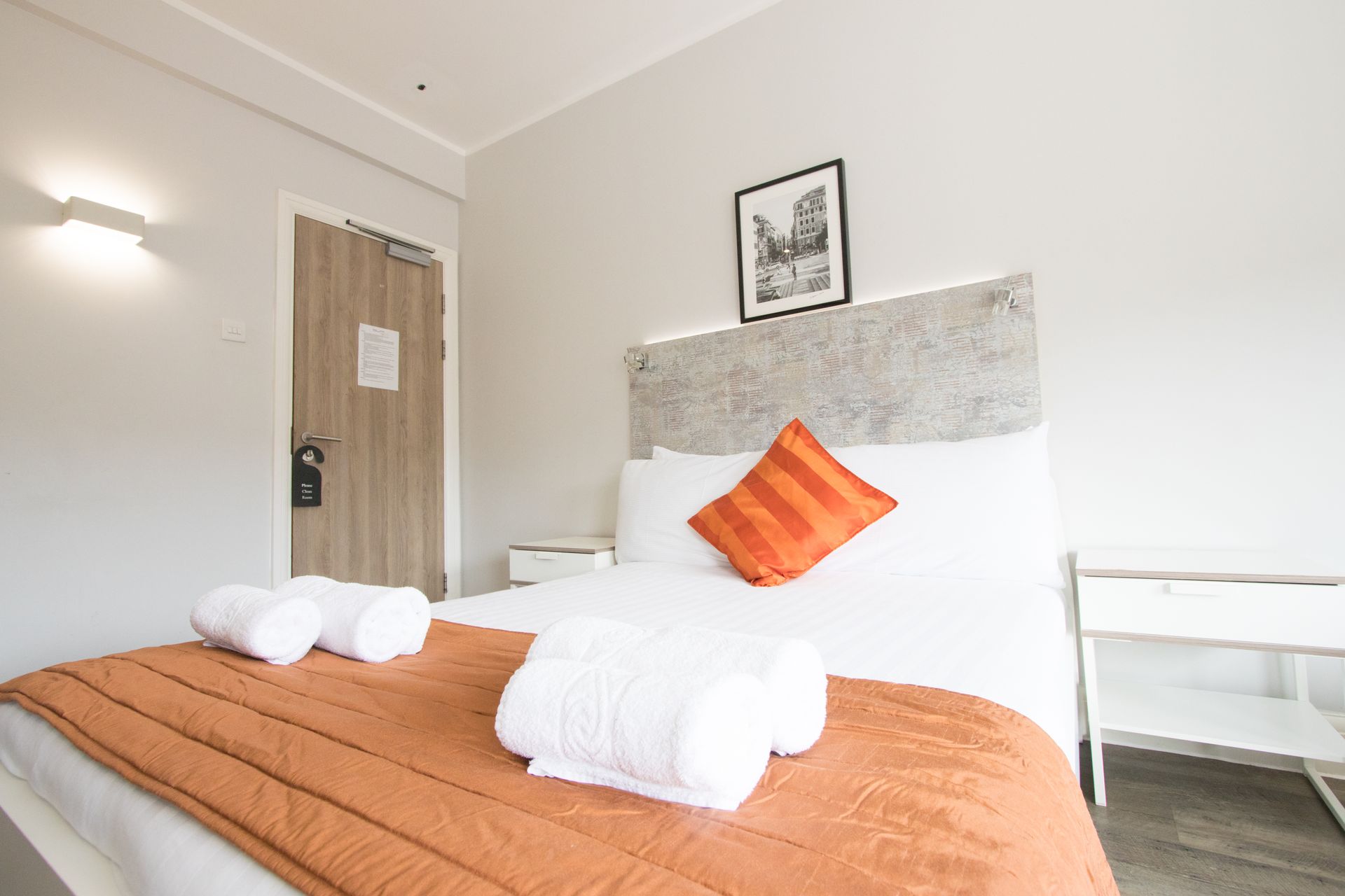 A hotel room with a bed and towels on it