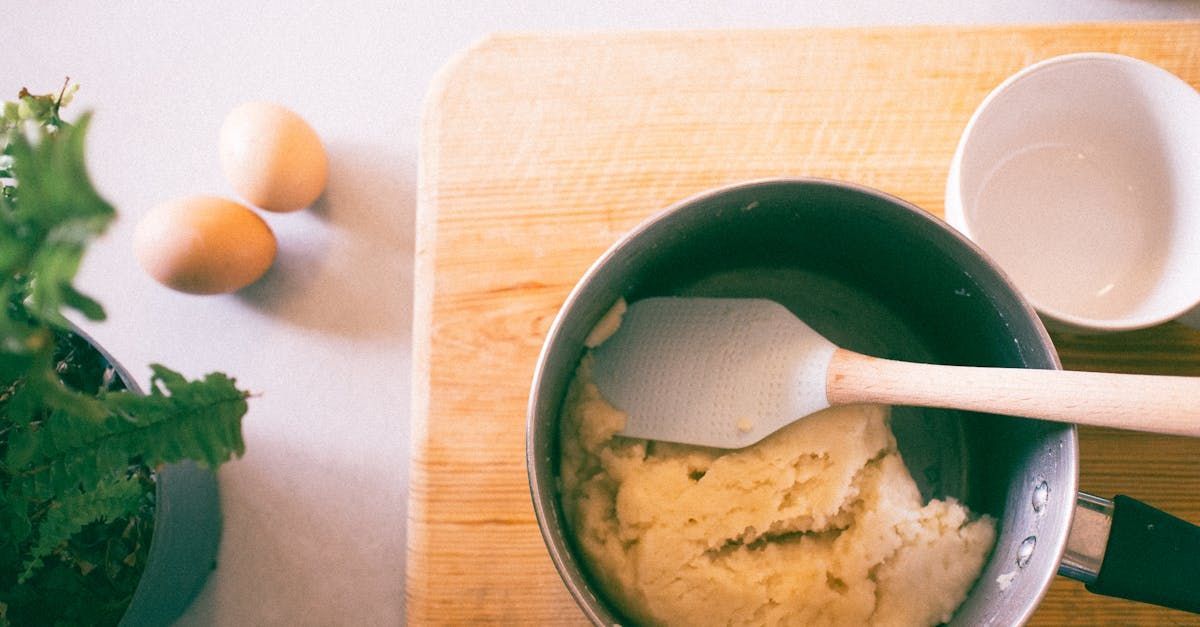 A pot of mashed potatoes with a spatula in it.