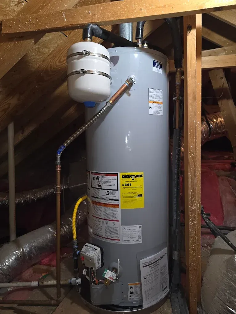 A water heater is sitting in the attic of a house