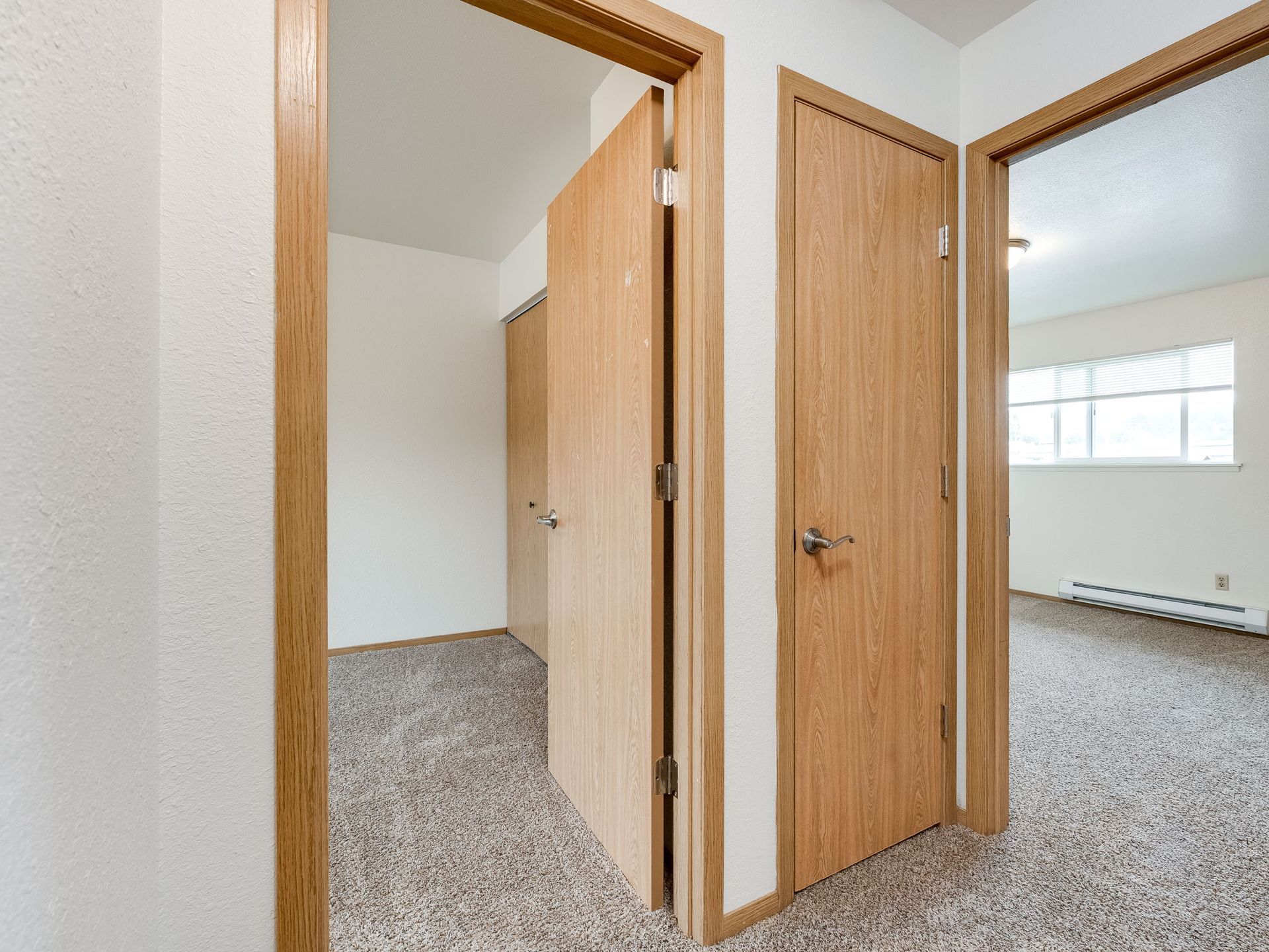 Southridge Apartments Townhome upstairs hallway looking into both bedrooms.