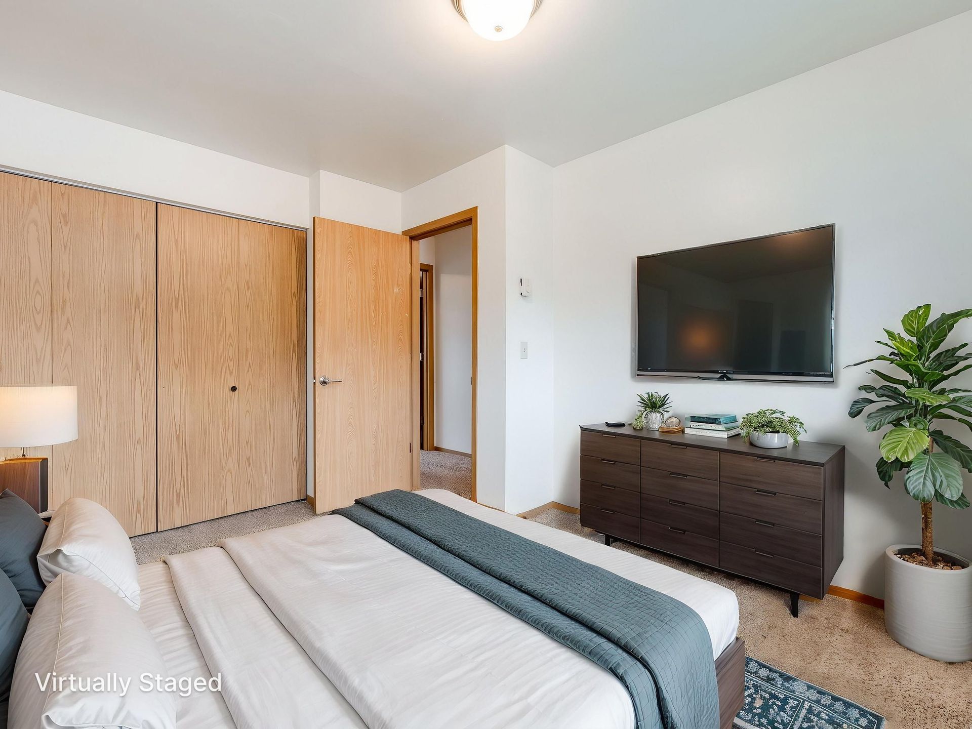 Southridge Apartments Townhome bedroom 1 with view of window with view of door and closet virtually staged.