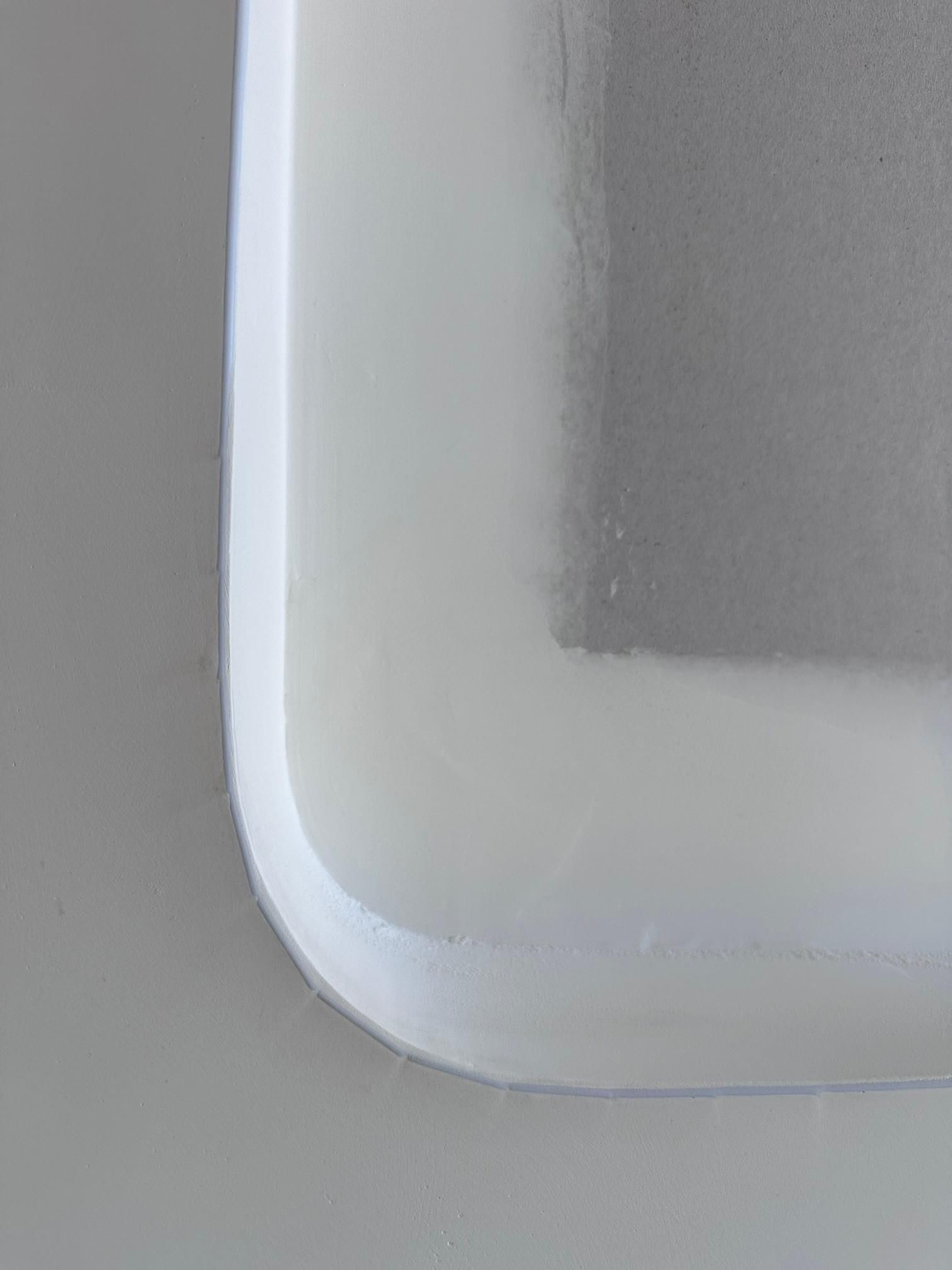 A close up of a white plastic container on a table.