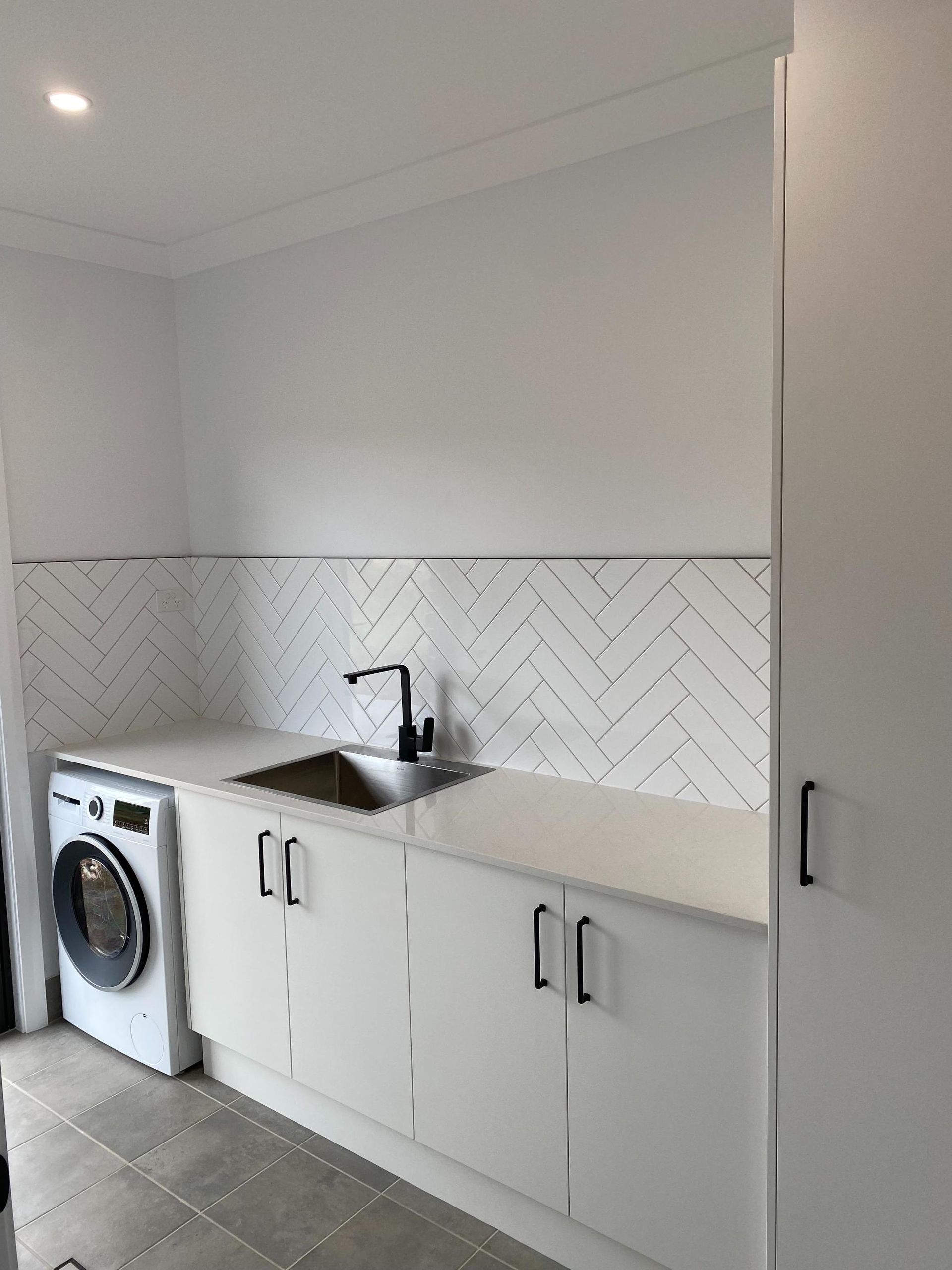 A bathroom with two sinks and a large mirror.