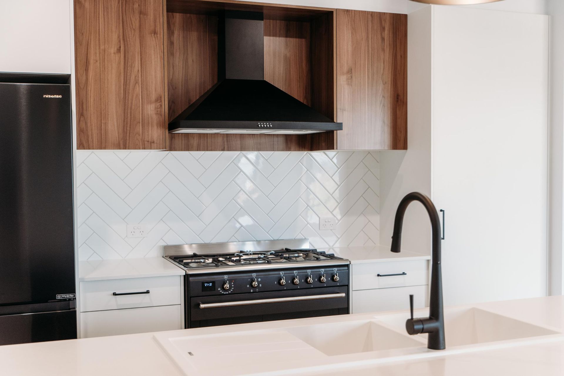 A kitchen with a stove , sink , and refrigerator.