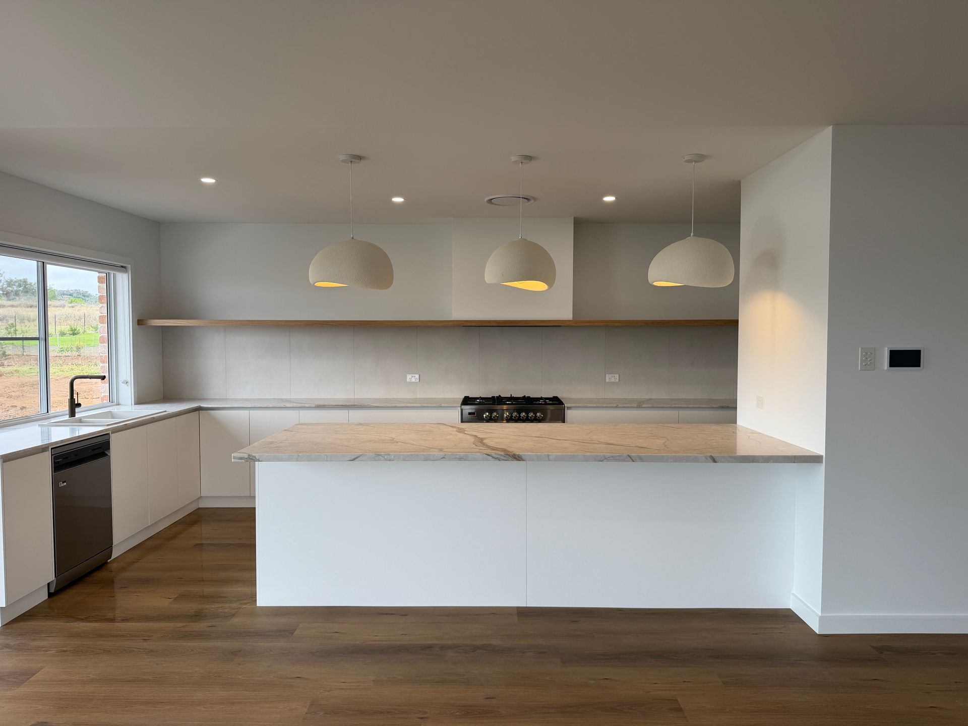 A kitchen with wooden cabinets and a bottle of wine on the counter