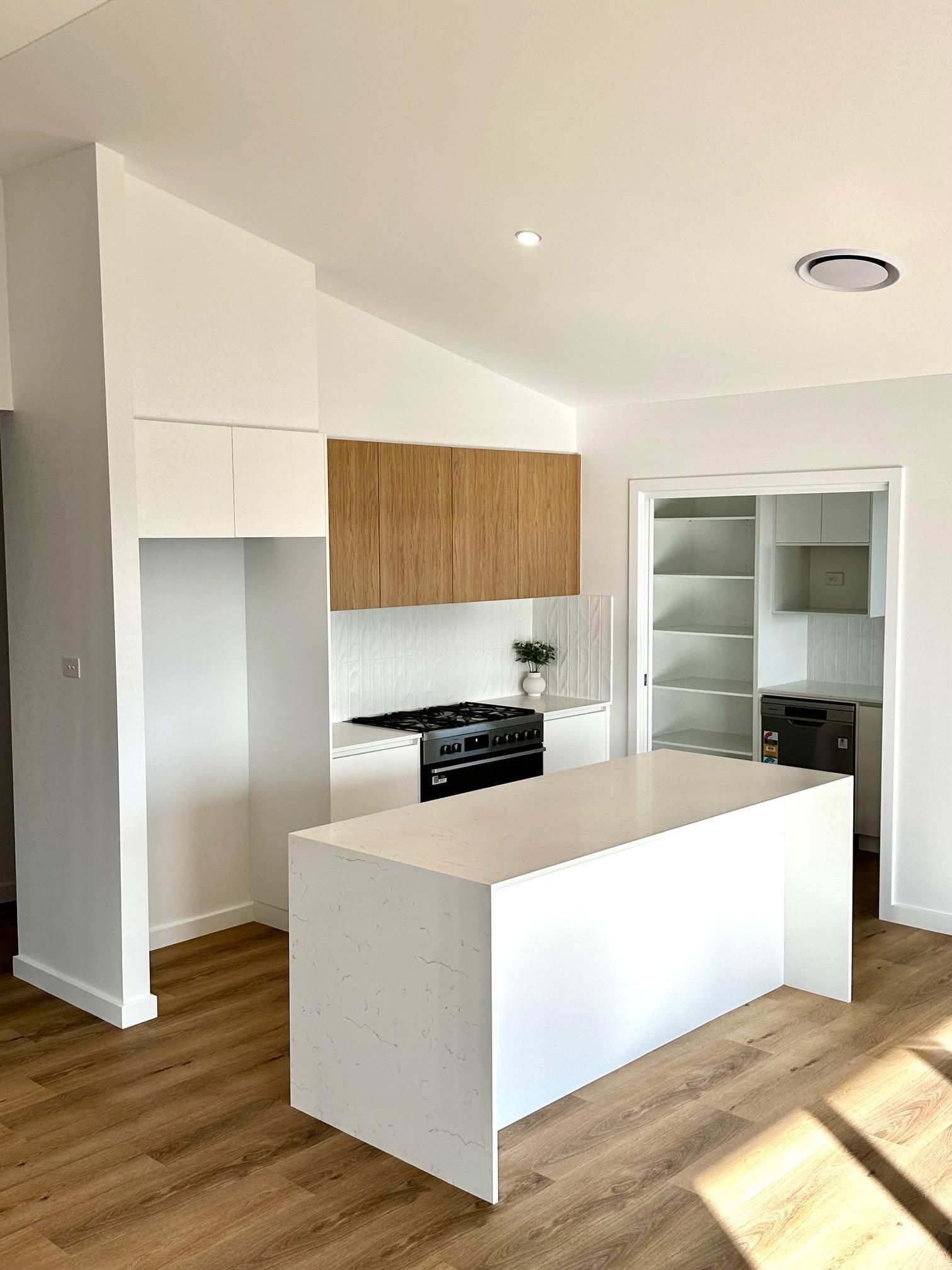 A kitchen with a large island in the middle of the room.