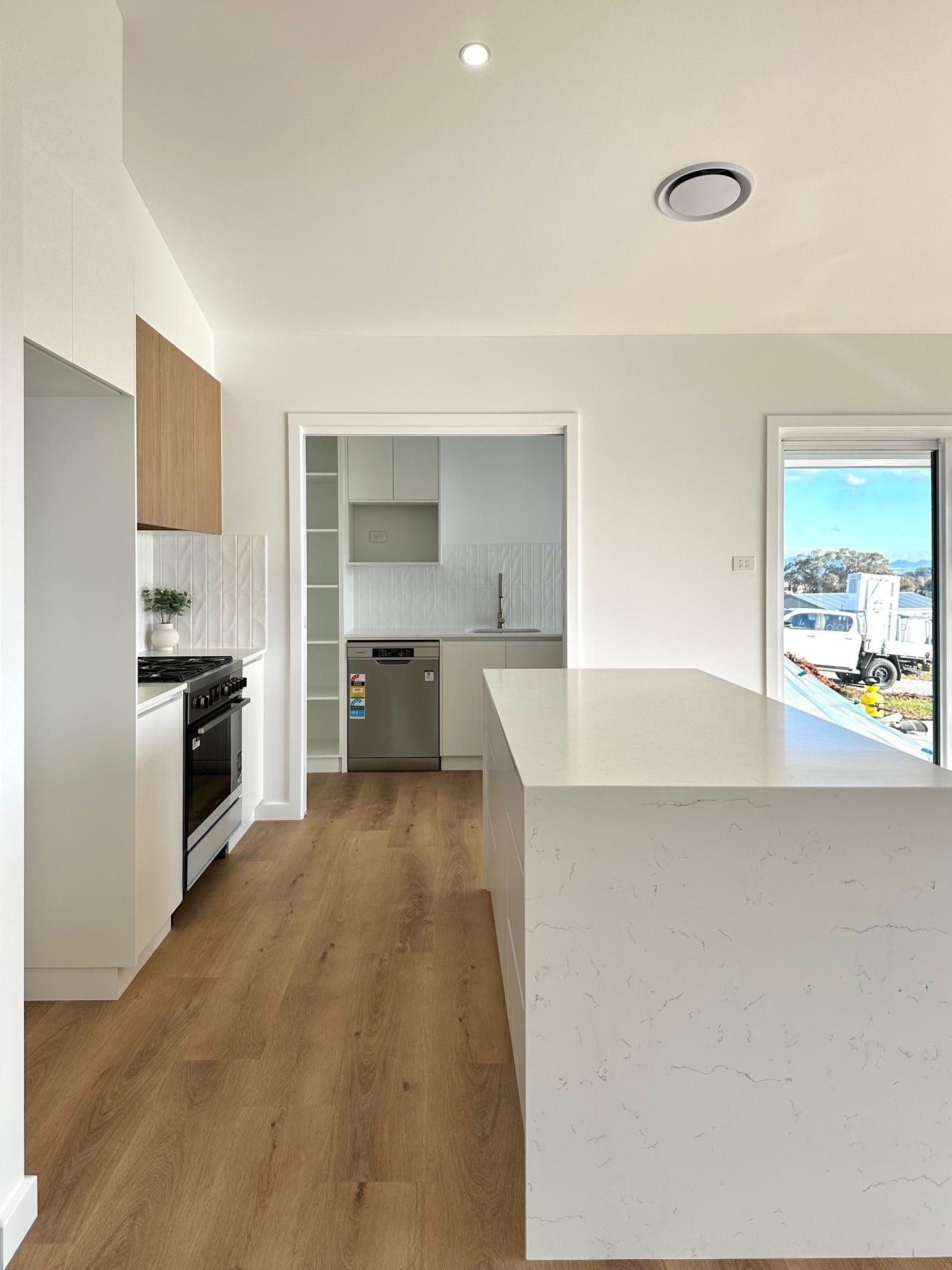 There is a large island in the middle of the kitchen.