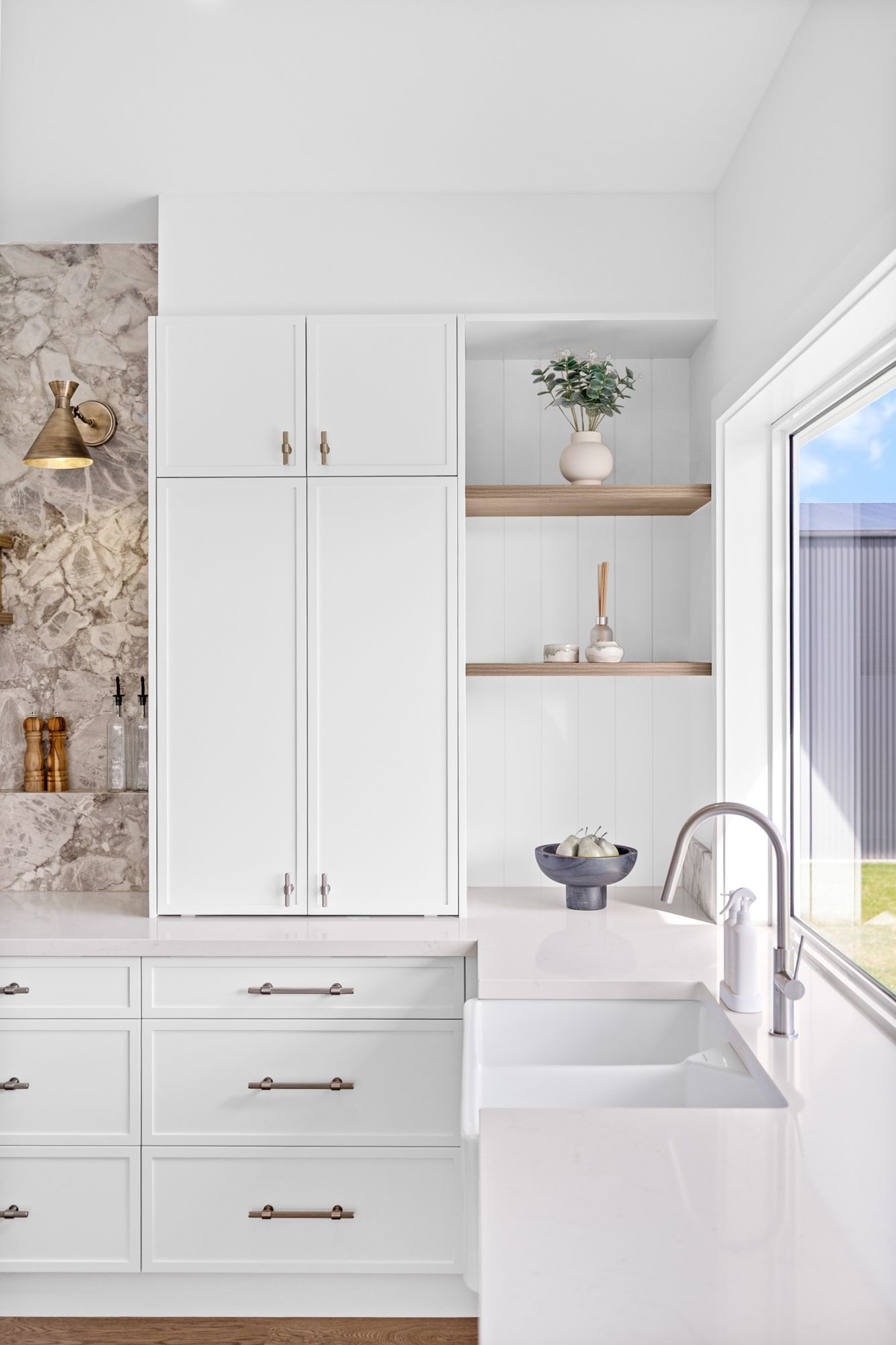 A kitchen with black cabinets and stainless steel appliances