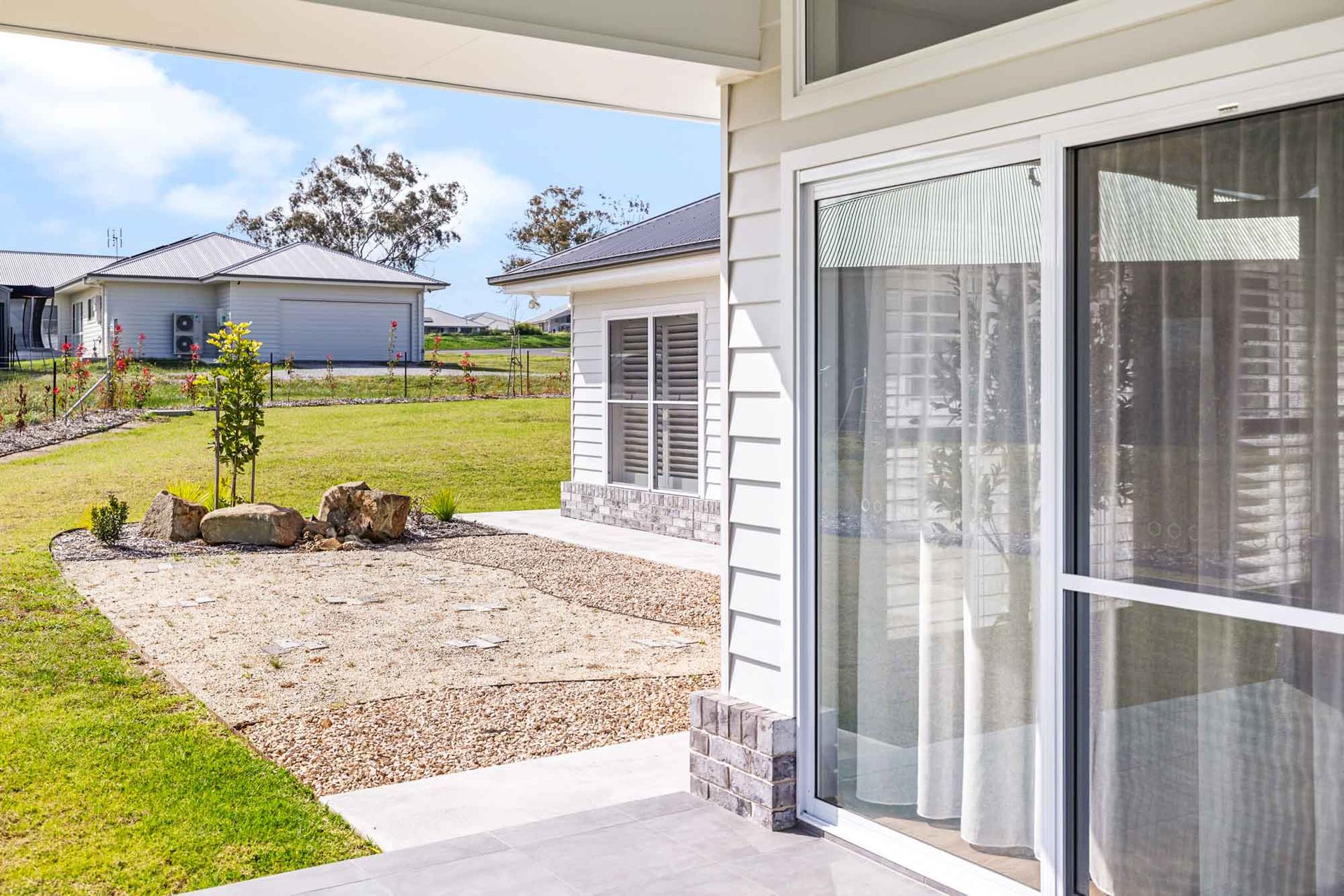 A large empty room with a lot of windows and hardwood floors.