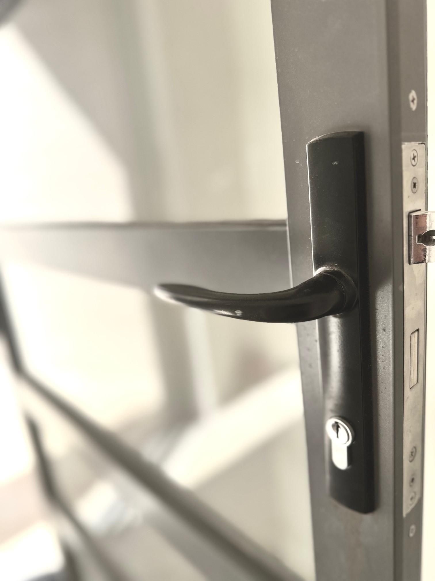 A close up of a door handle on a door.