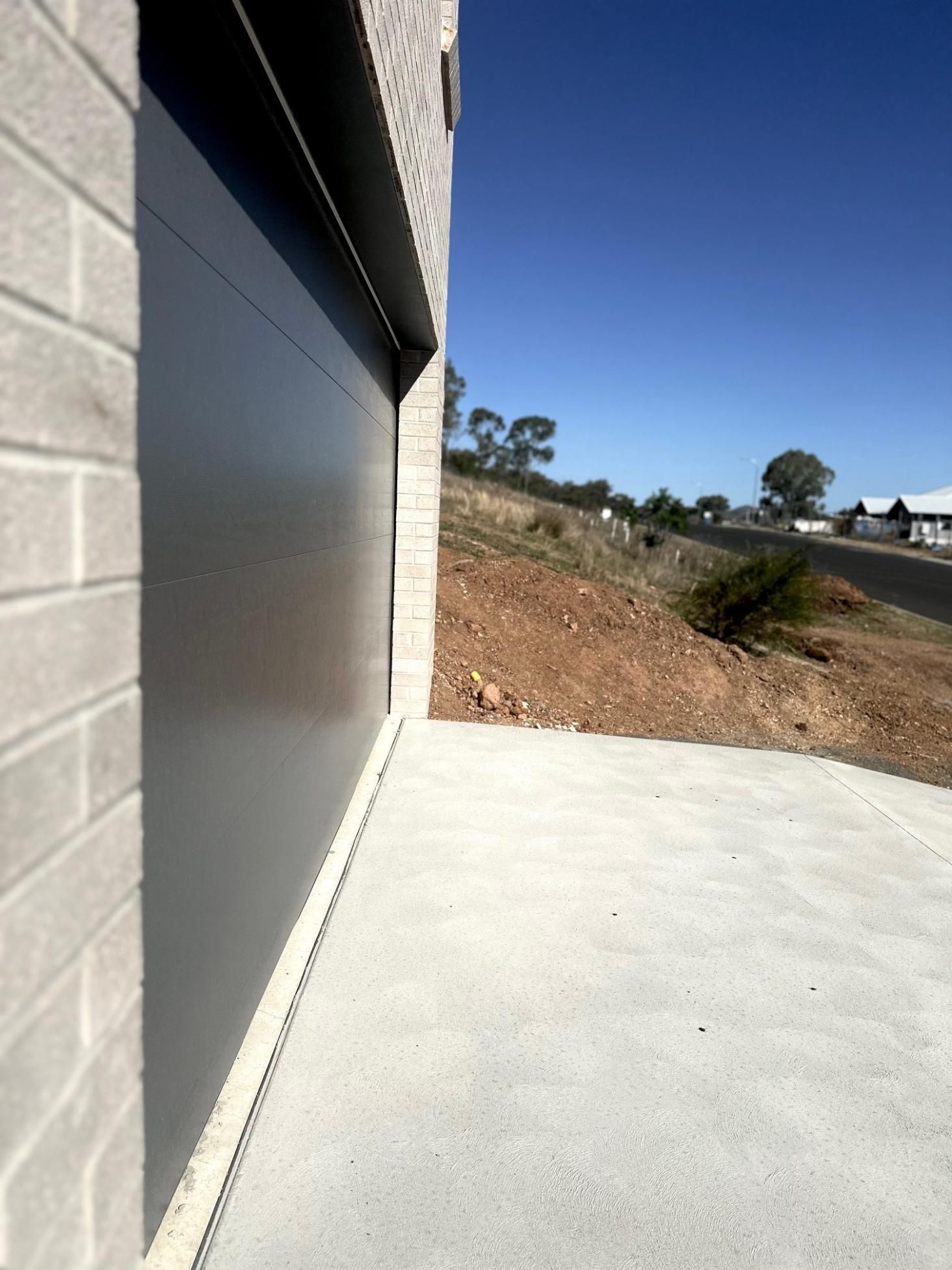 A brick building with a gray garage door