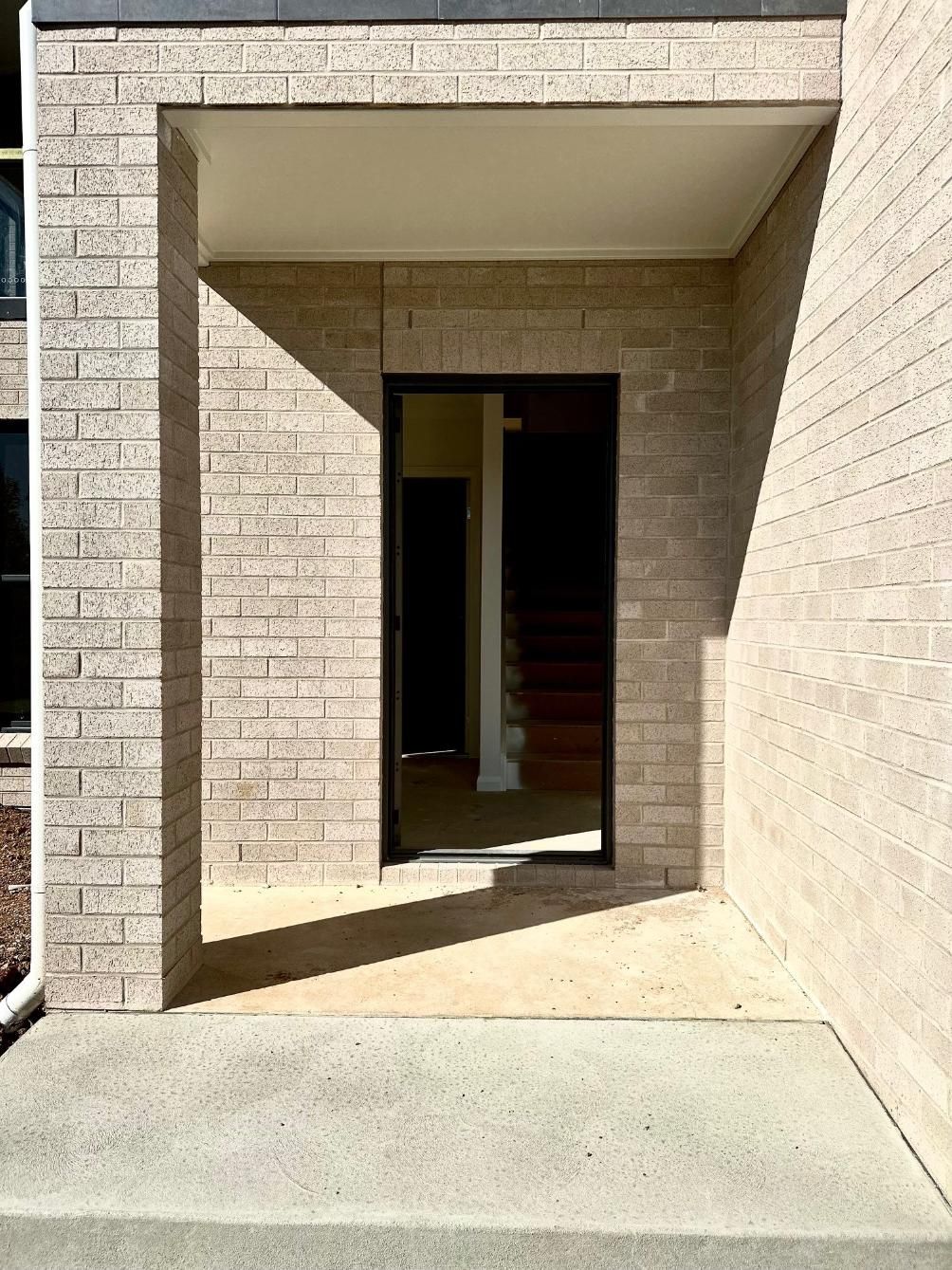 A brick building with a door that is open
