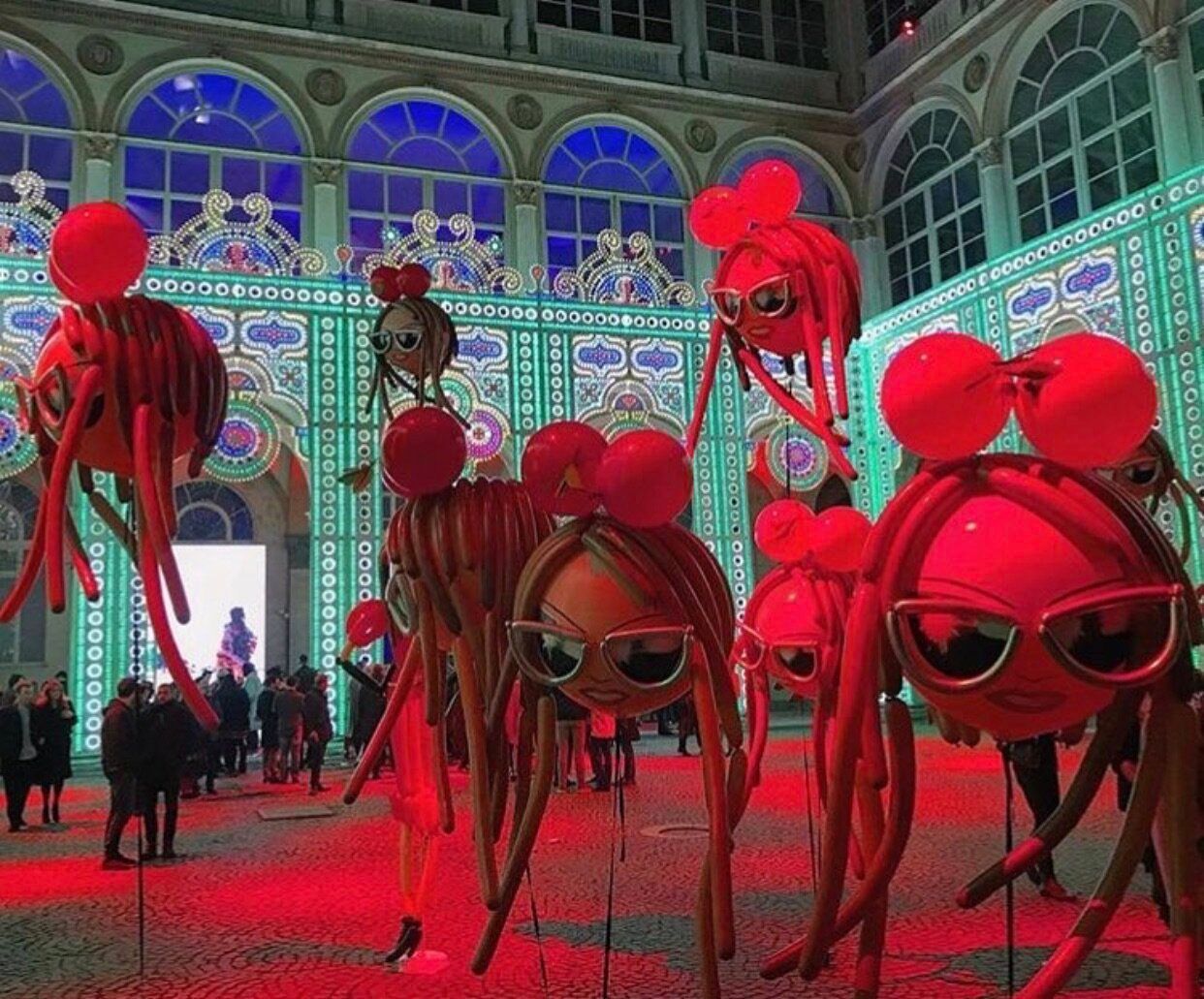 A group of red bugs wearing sunglasses and bows