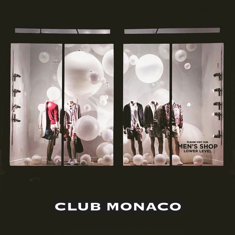 A club monaco store front with mannequins in the window