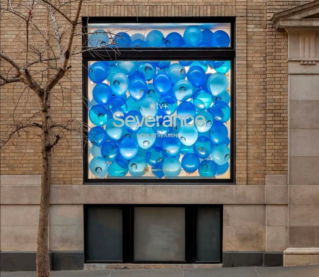 A window with blue balloons and the word severance on it