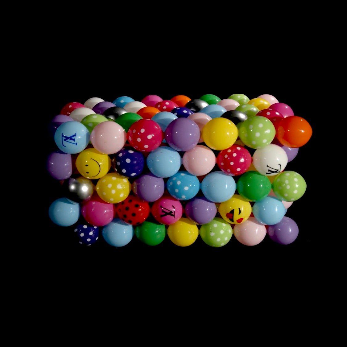 A bunch of colorful balls on a black background