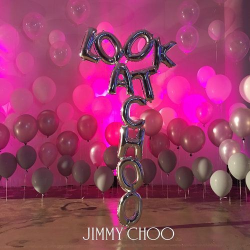 Silver balloon letters spell 