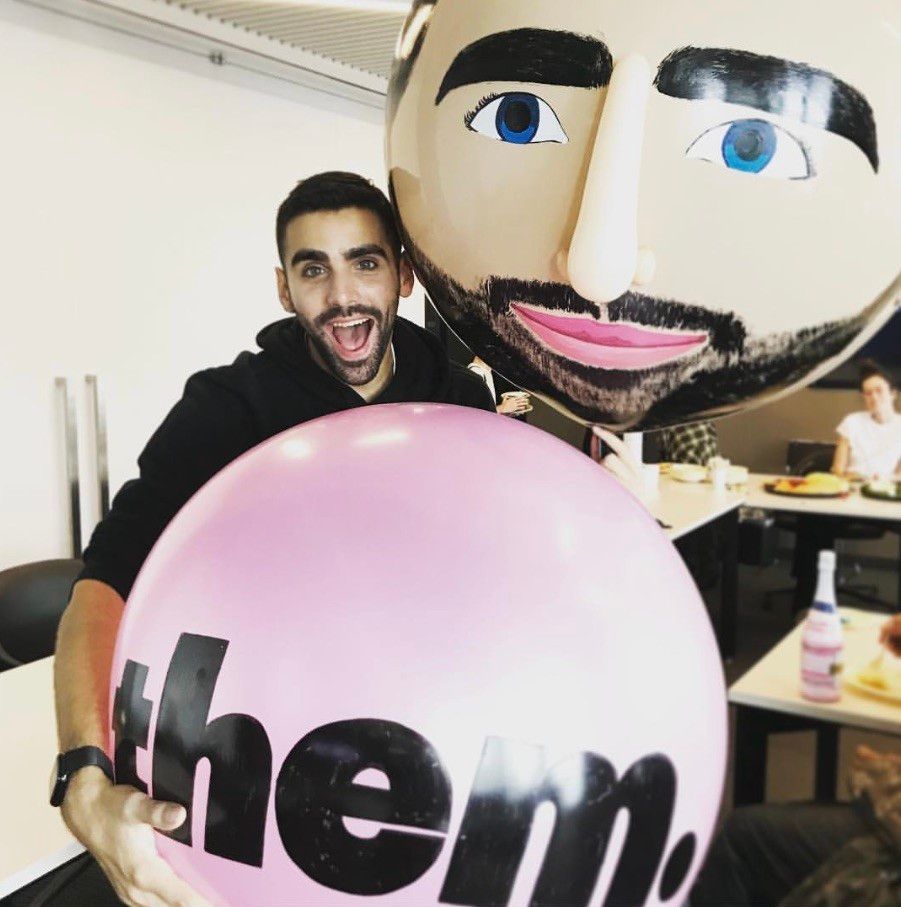Man holding a pink balloon with 