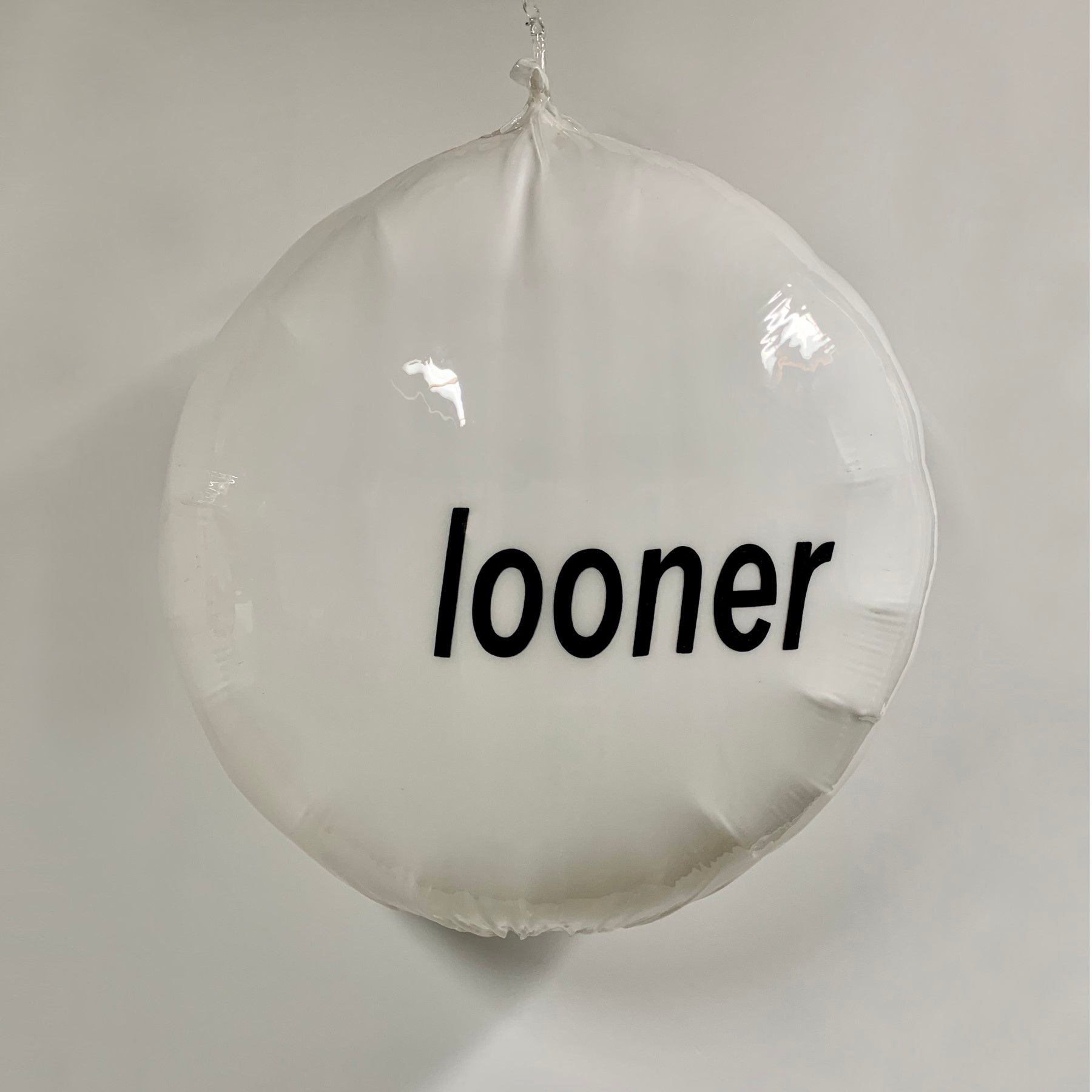 A white balloon with the word looner written on it