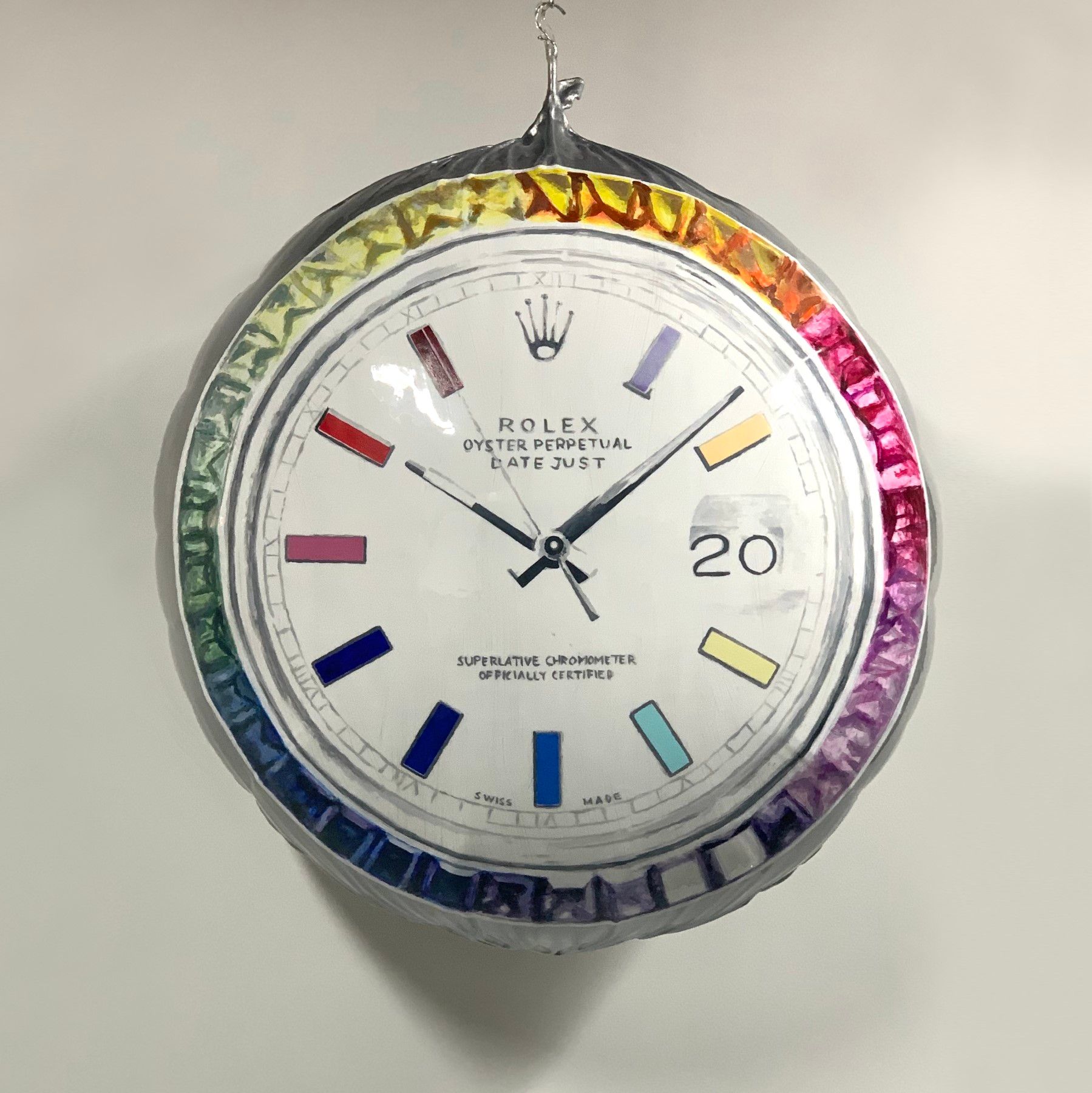 A rolex watch with a rainbow colored face