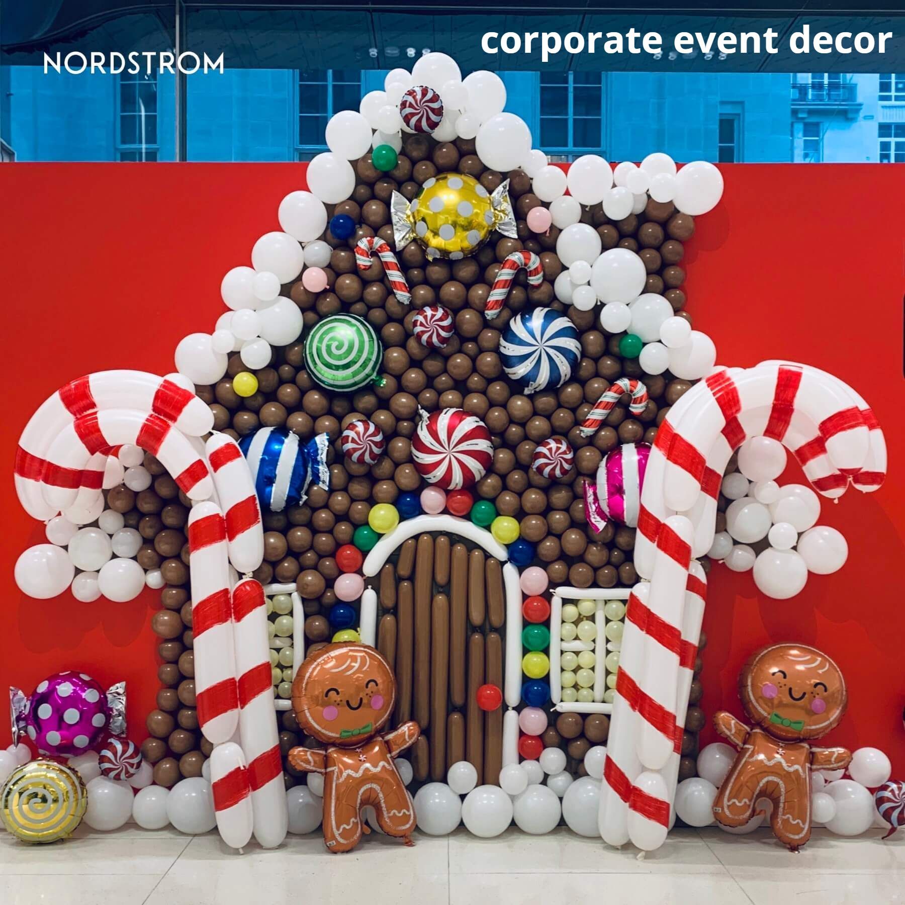 A gingerbread house made out of balloons and candy canes
