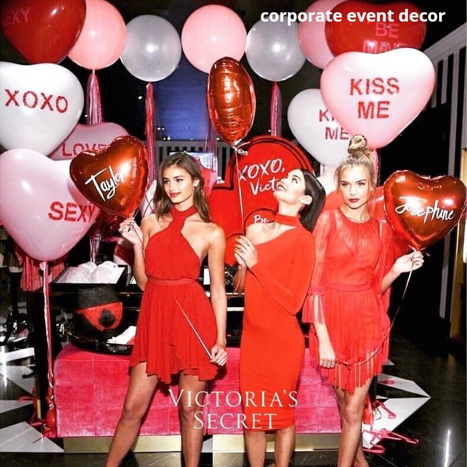 A group of women holding balloons that say kiss me