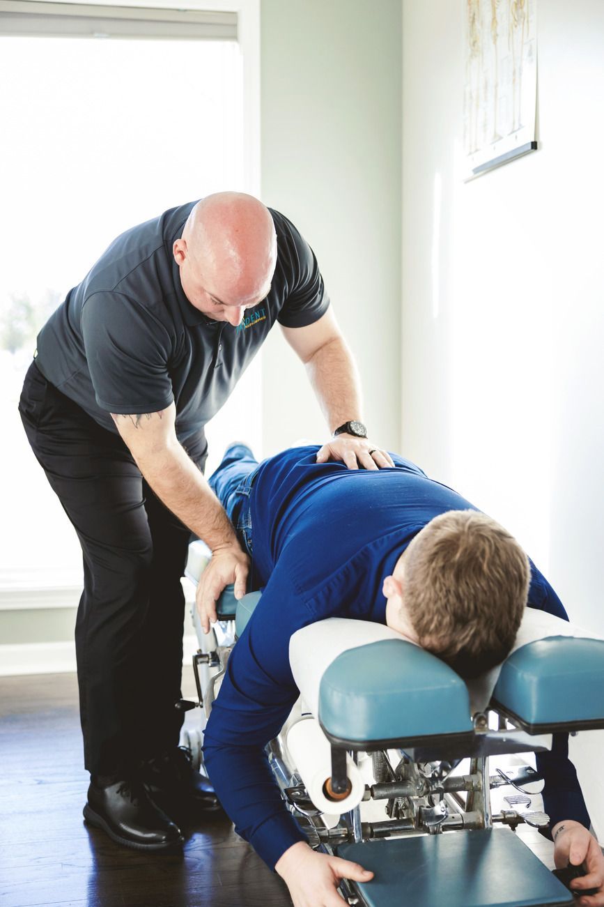 Chiropractor adjusting patient's back.