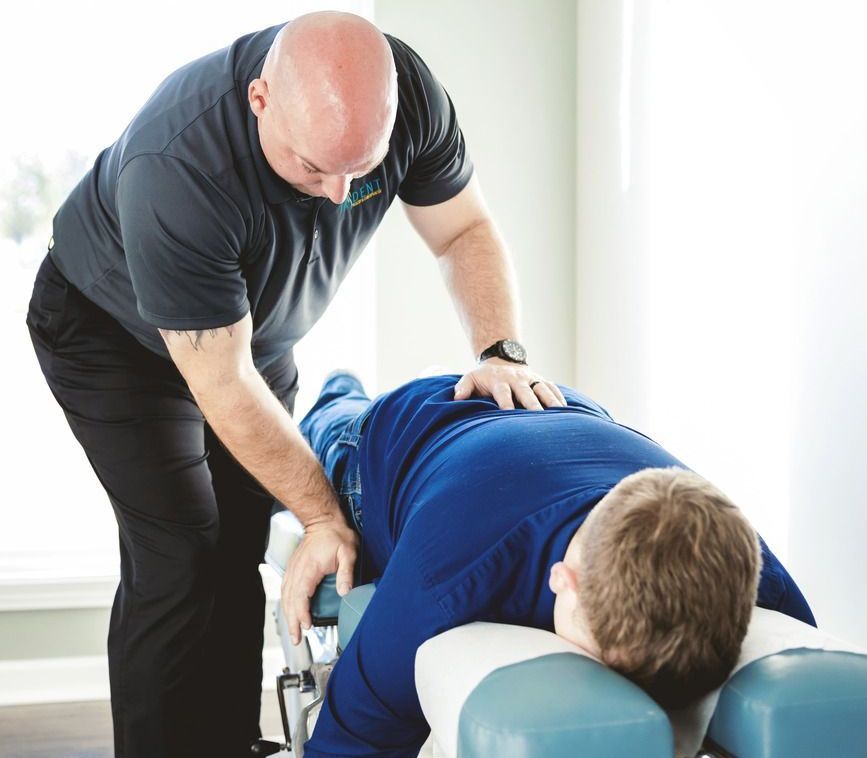 Chiropractor adjusting lower back.
