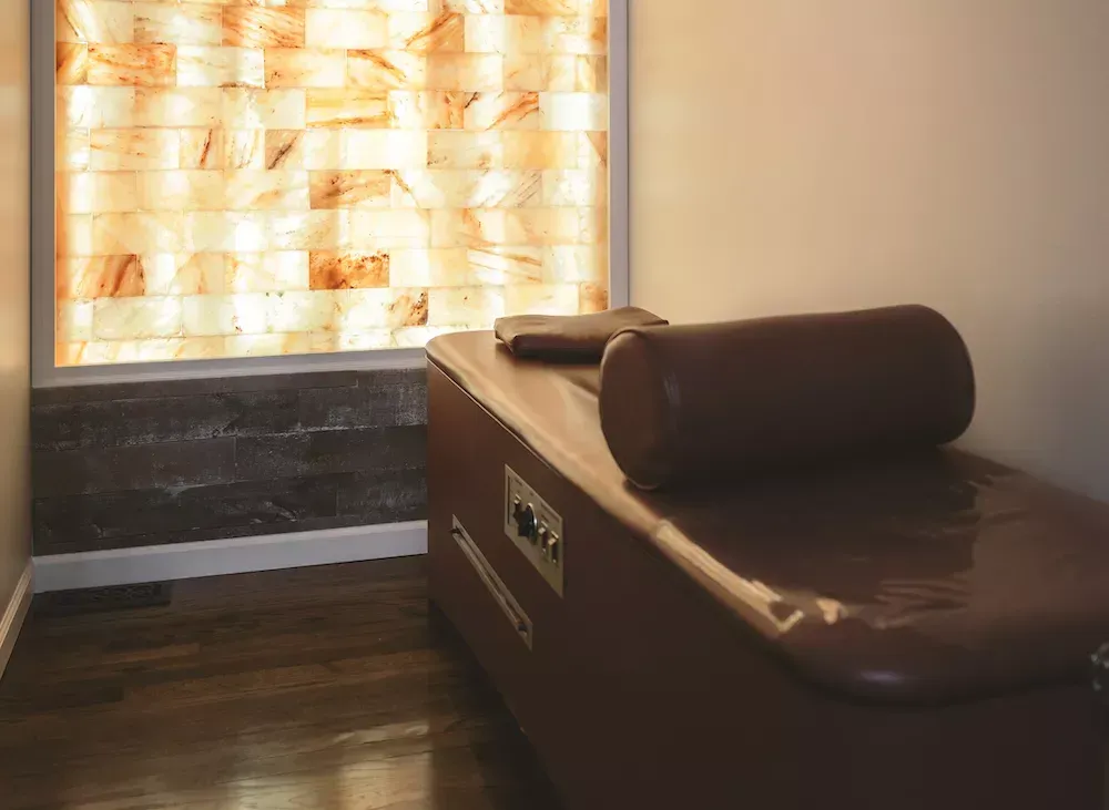 Salt therapy room with a relaxation bench and salt wall.