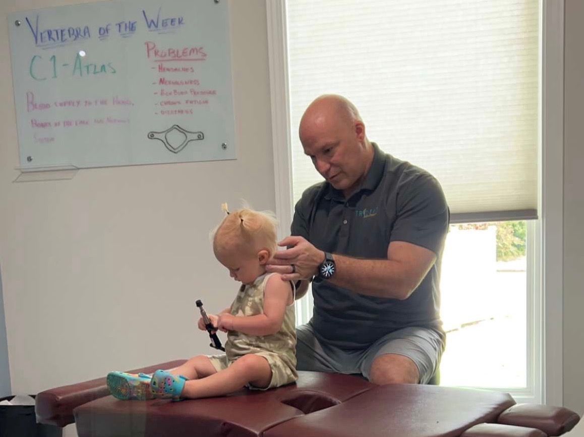 Chiropractor examining a baby.