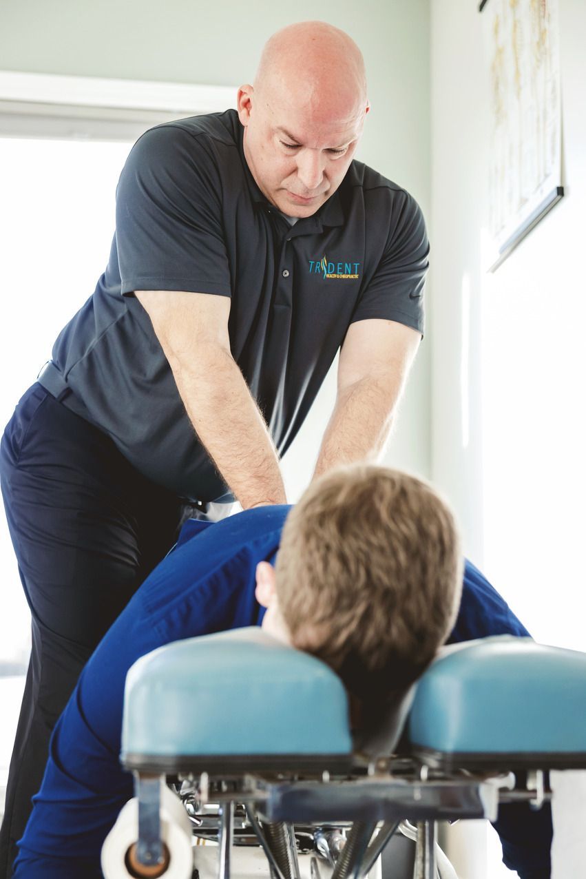 Chiropractor treating patient.
