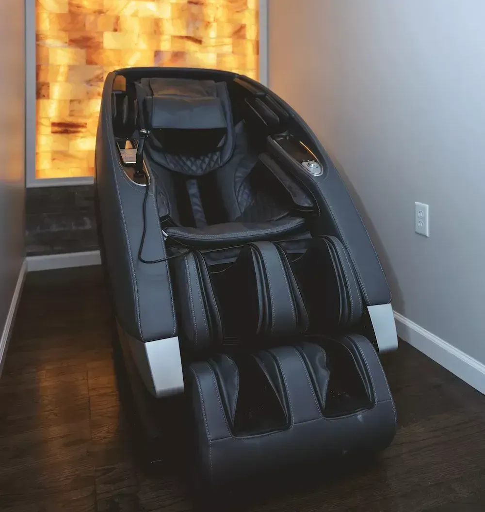 A black massage chair in a room.