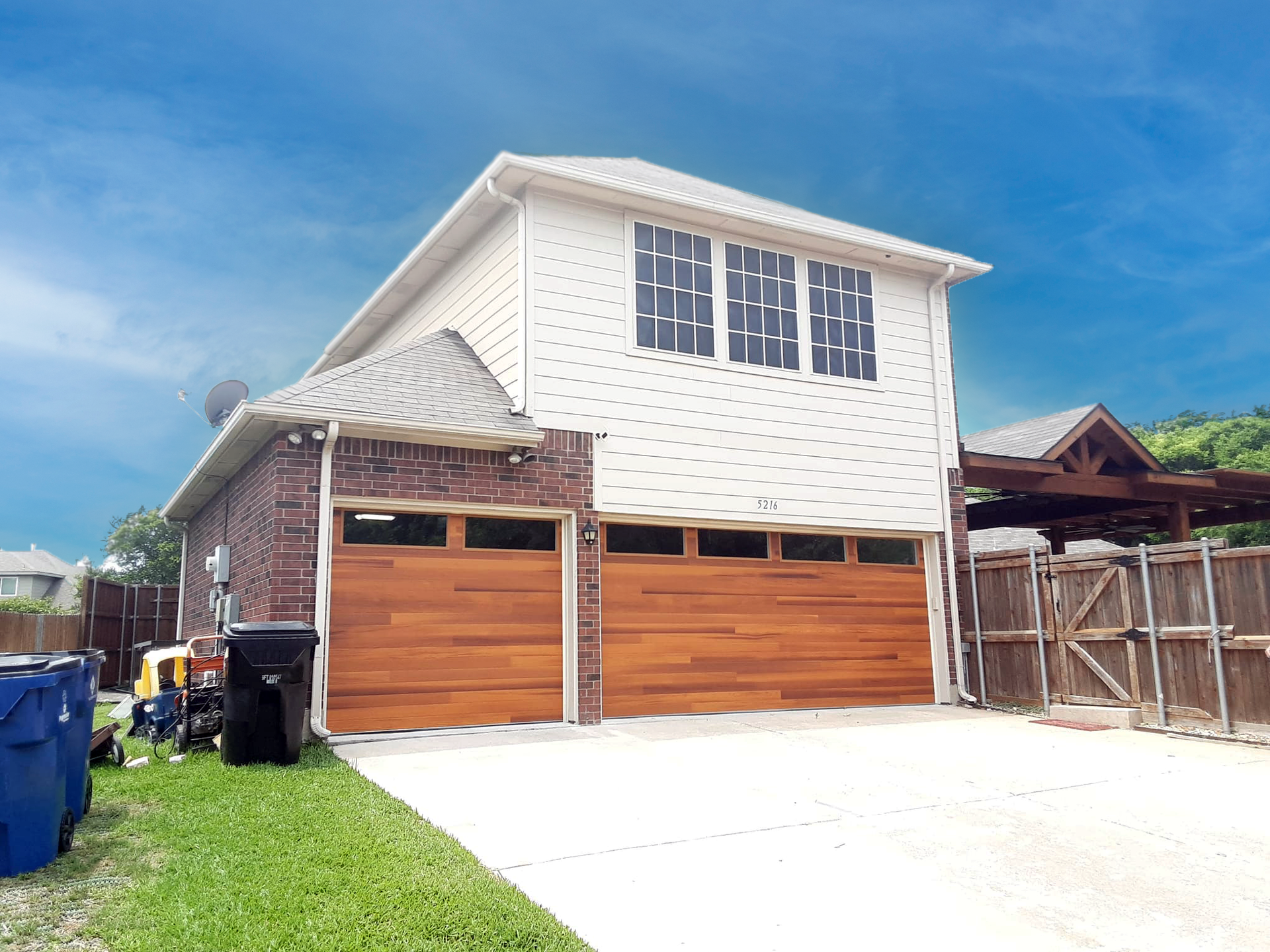 A white house with a wooden garage door