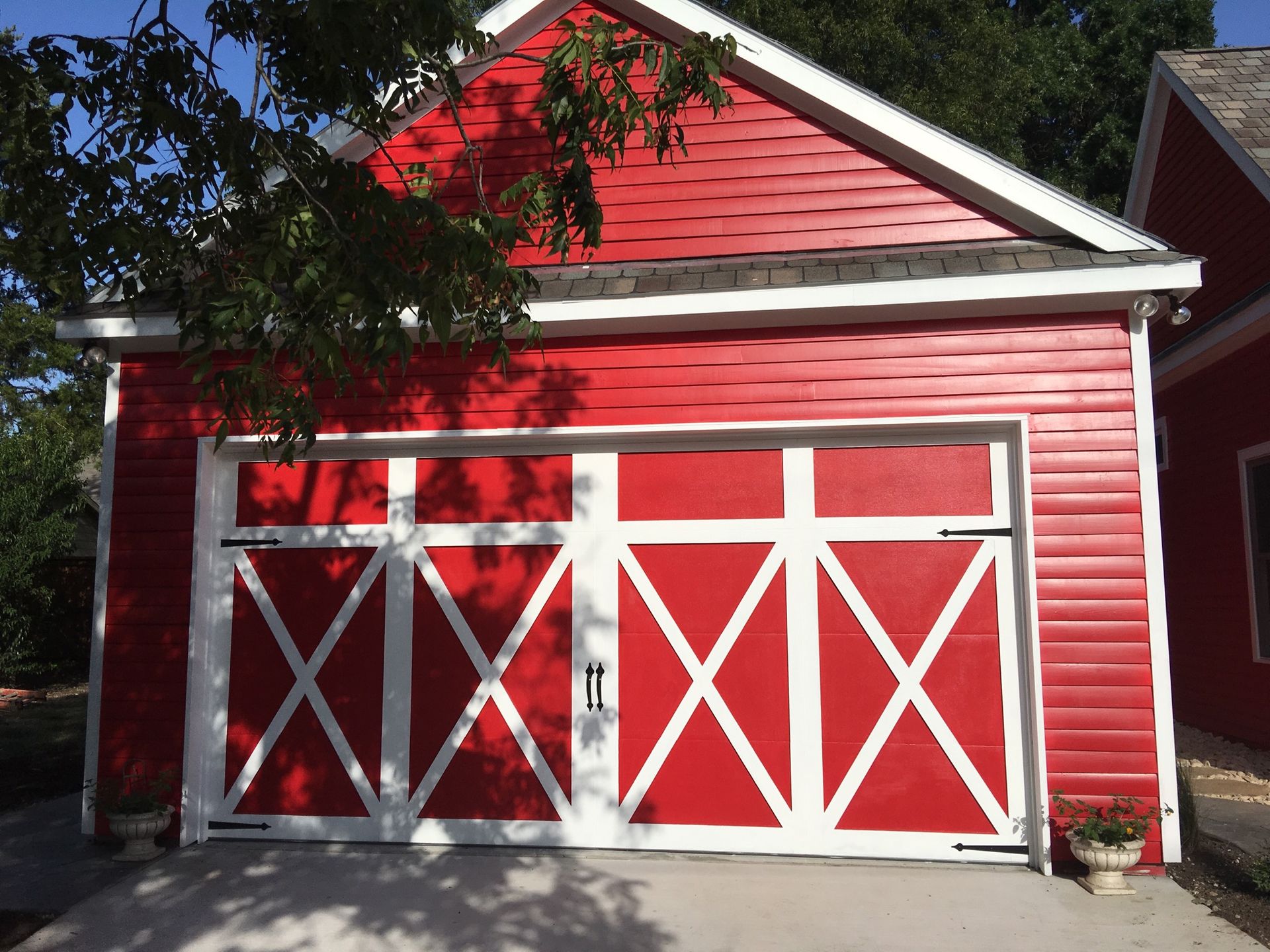 A red garage with white trim and a sliding door