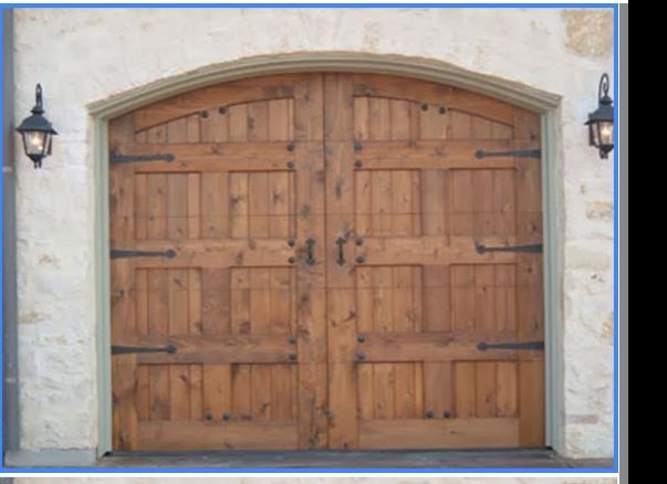 A picture of a wooden garage door on a stone wall