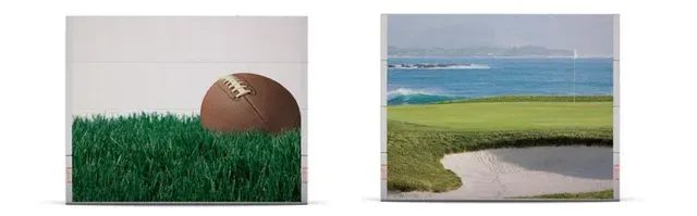 A football is sitting in the grass next to a golf course.